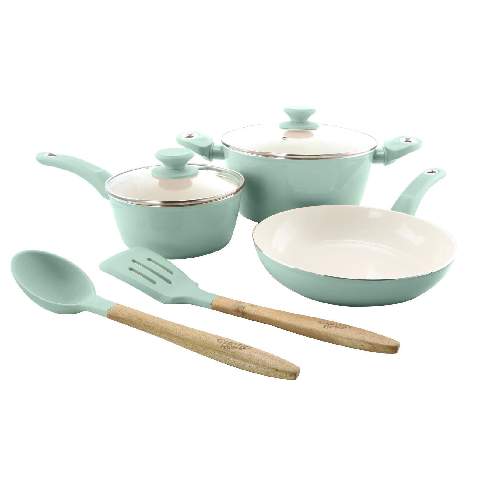 The image features a set of green and white cookware, including a teapot, a bowl, and a spoon. The teapot is placed next to the bowl, and the spoon is positioned nearby. The cookware is arranged on a white background, creating a clean and minimalist presentation.