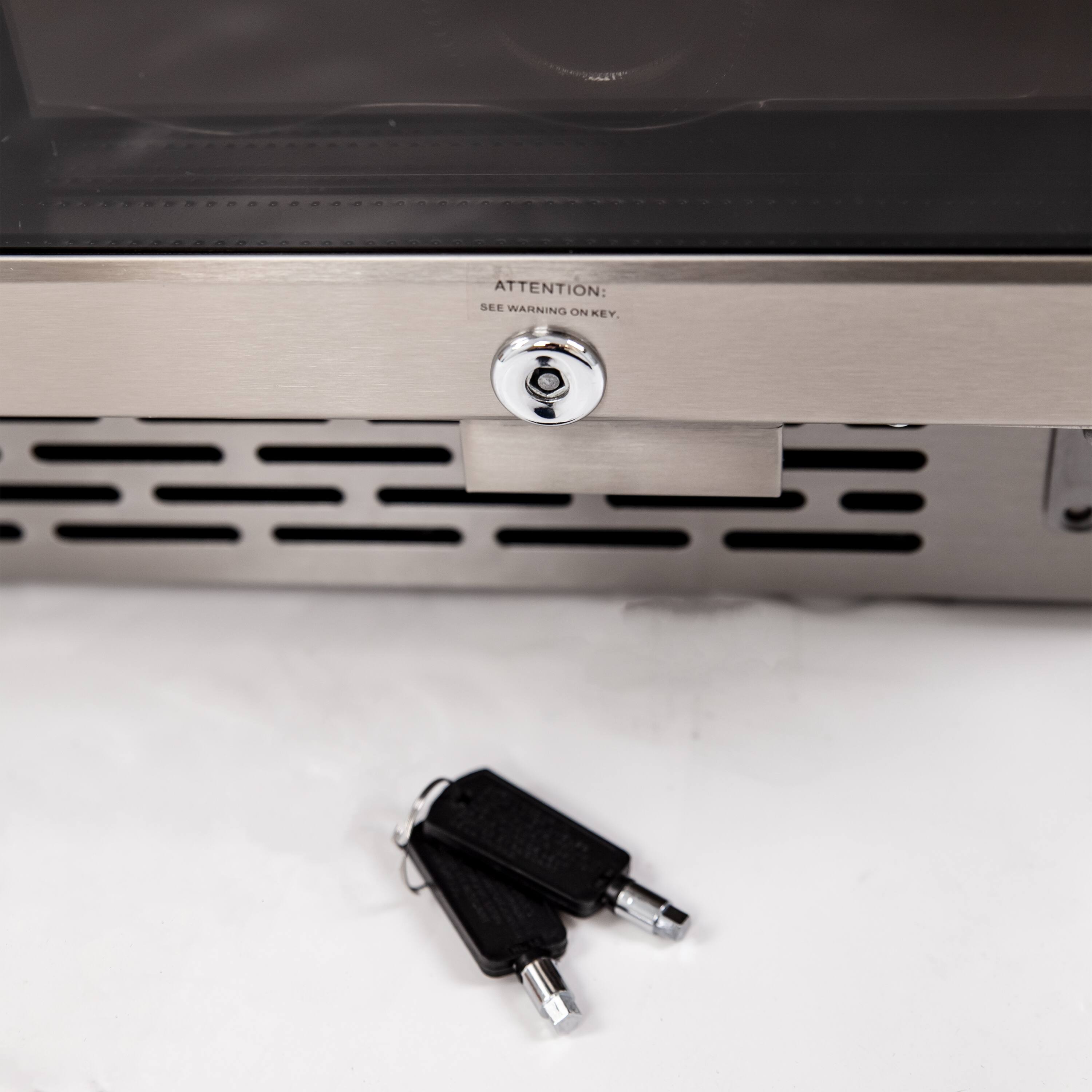 The image features a microwave with a keypad and a warning label. The warning label is located on the keypad, and it says "Attention: See Warning on Key." This suggests that there is a warning message associated with the keypad, which users should pay attention to while using the microwave.