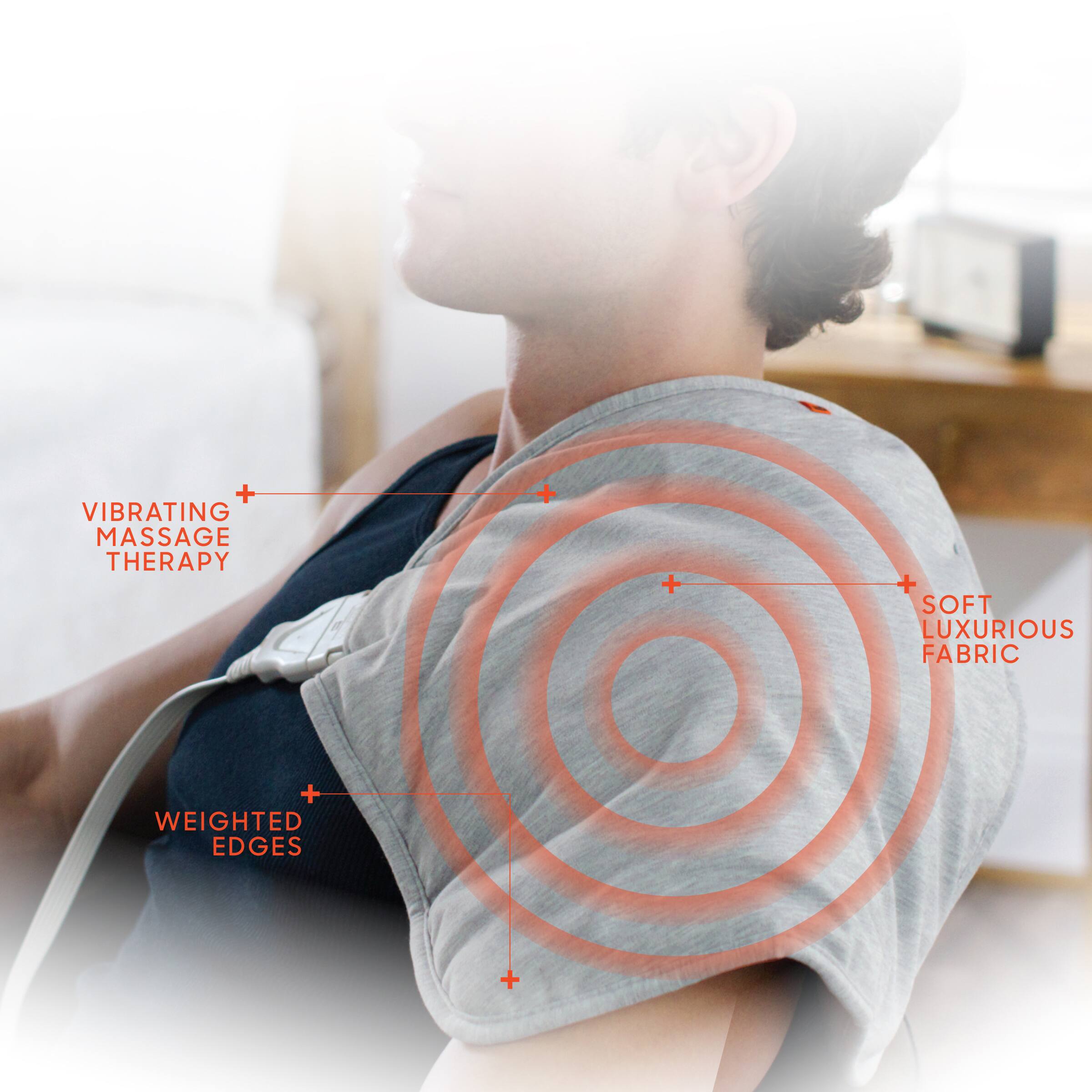 The text on the image reads: "Vibrating Massage Therapy + Soft Luxurious Fabric + Weighted Edges."