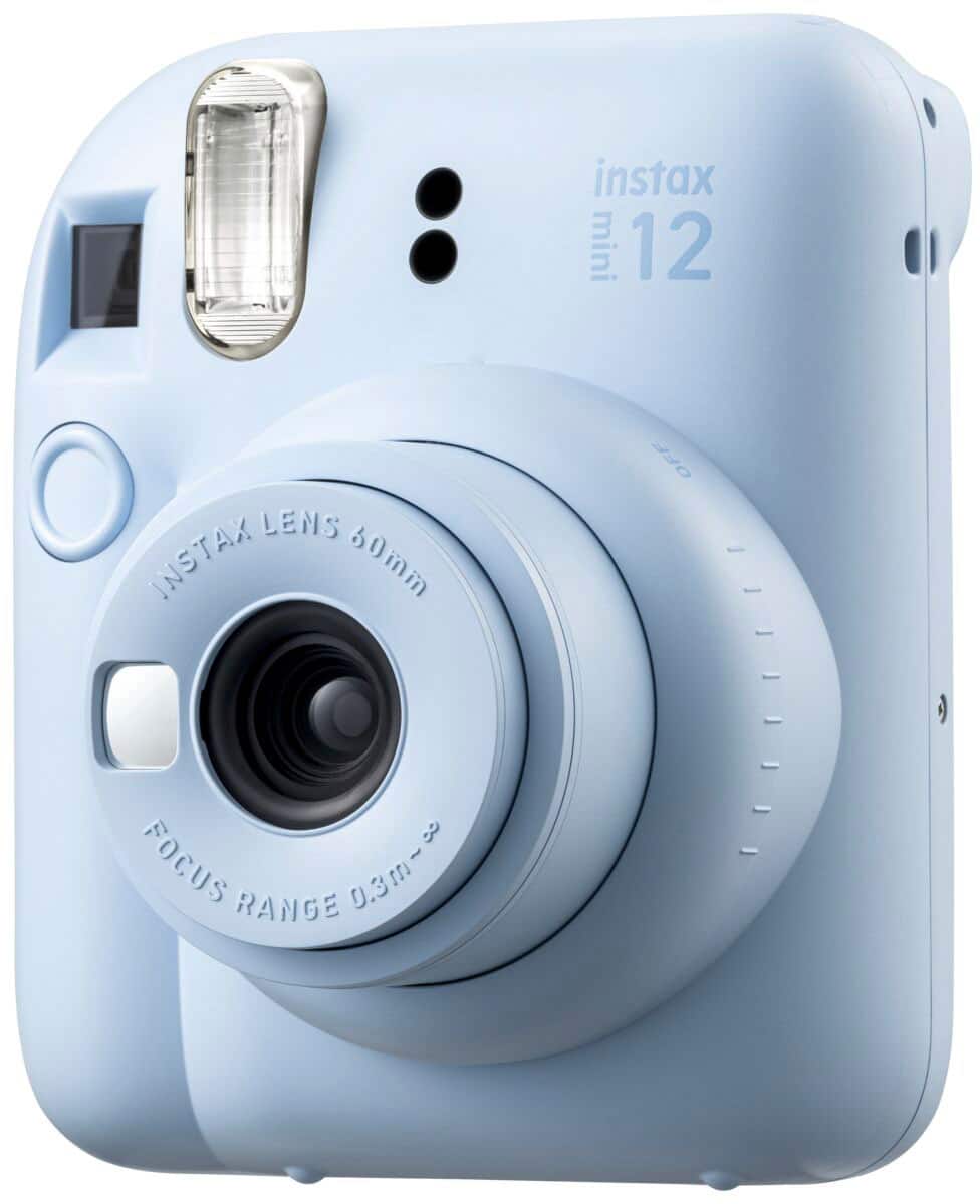 The image features a white Instax Mini 12 camera with a lens that has a focus range of 0.3m to 0.3m.