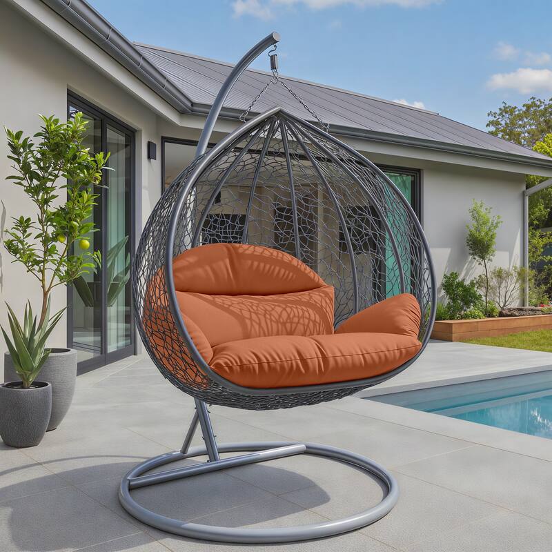 Angle. LeisureMod - Recluse Grey Wicker Hanging Egg Chair - Modern Indoor Outdoor Swing with Stand, 440lb Capacity - Orange.