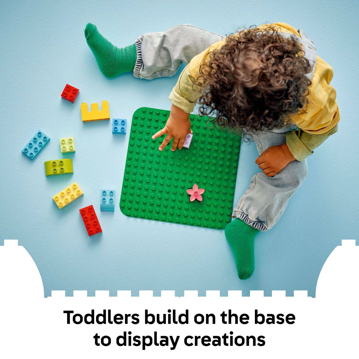 Toddlers build on the base to display creations.