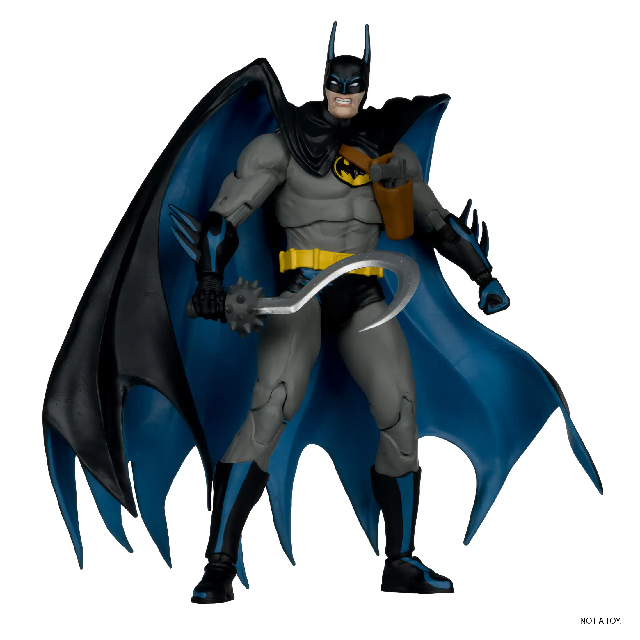 The image features a Batman action figure, which is a toy, not a real person. The action figure is wearing a Batman costume and holding a Batman-themed item, such as a Batarang or a Batman-themed gadget. The figure is posed in a dynamic stance, with its arms outstretched, and it is standing on one foot. The action figure is a popular collectible among fans of the Batman franchise.