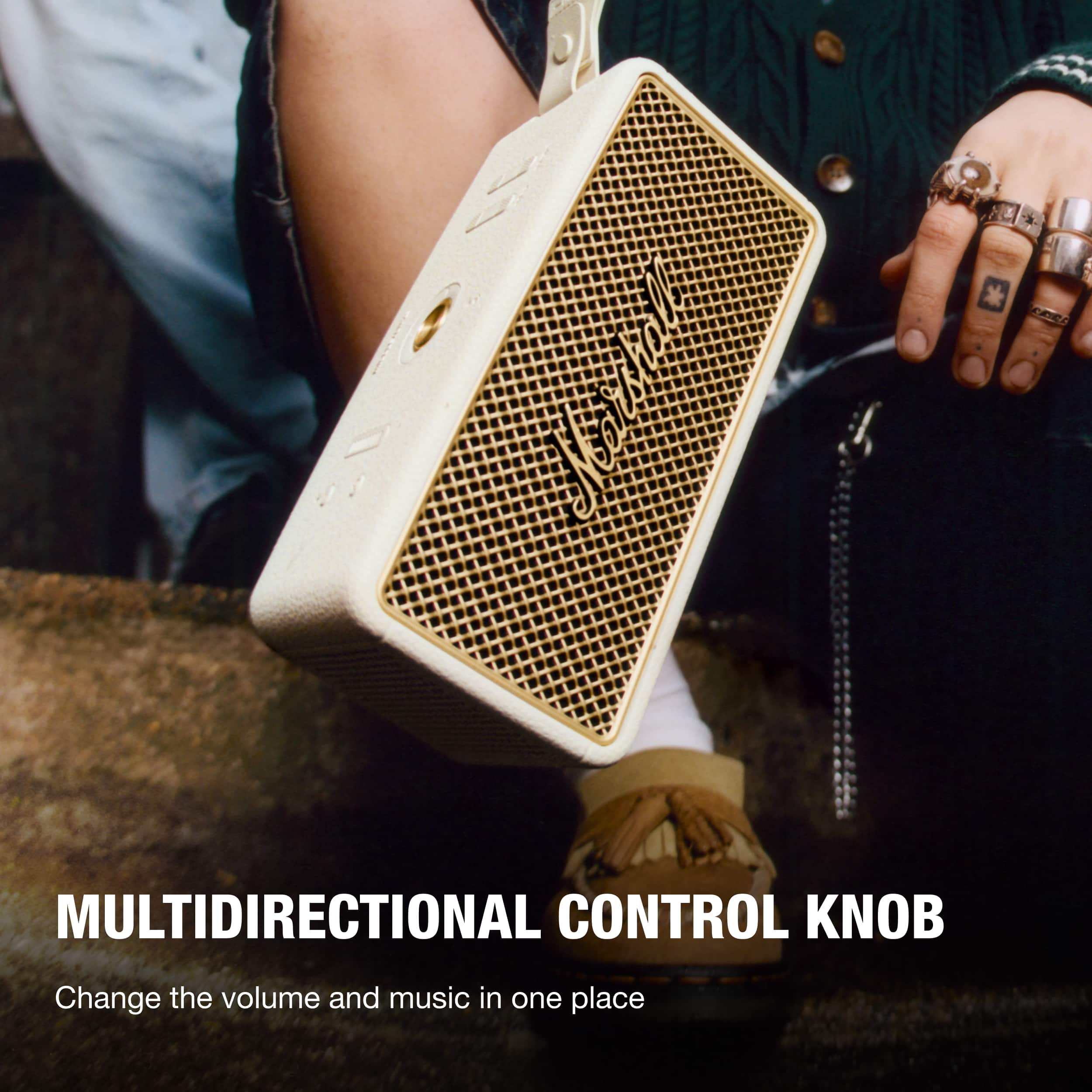 The text on the image reads "MULTIDIRECTIONAL CONTROL KNOB Change the volume and music in one place."