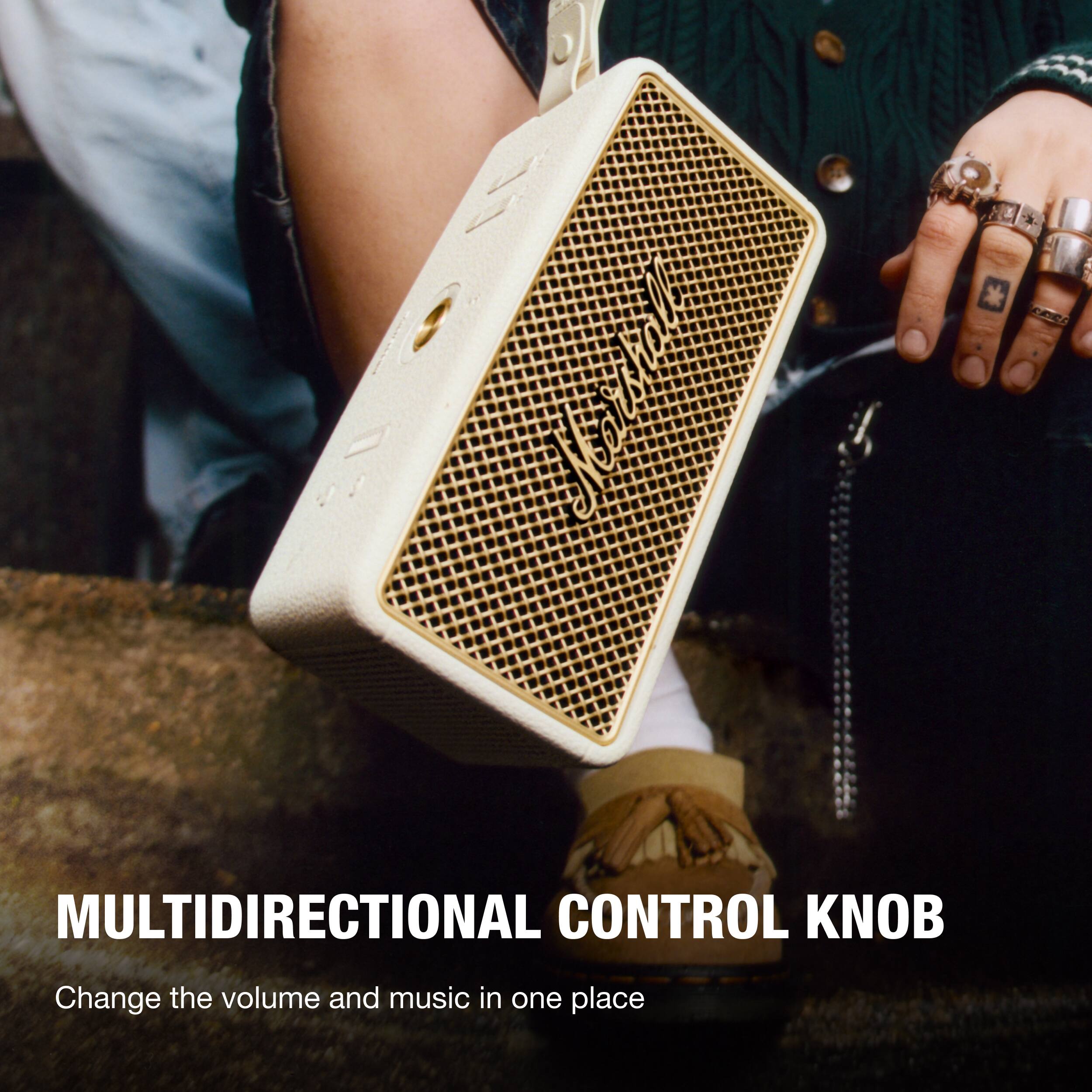 The text on the image reads "MULTIDIRECTIONAL CONTROL KNOB Change the volume and music in one place."