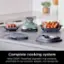 The image features a complete cooking system from Ninja, which includes a PowerPod, a big-batch 4-qt container, a small-batch 6-cup container, an adapter, and storage lids.
