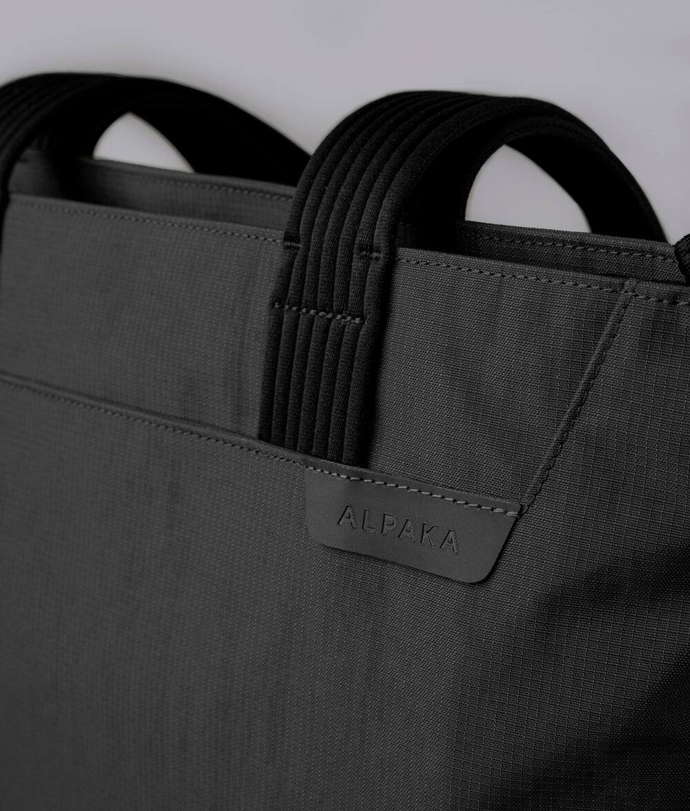 Alt View 7. ALPAKA - Flight Tote (M) Laptop Tote Bag for Work, Tote Bag Fits 14" MacBook Pro, Water Bottle Pocket, Luggage Pass-Through - Black Axoflux 400D.