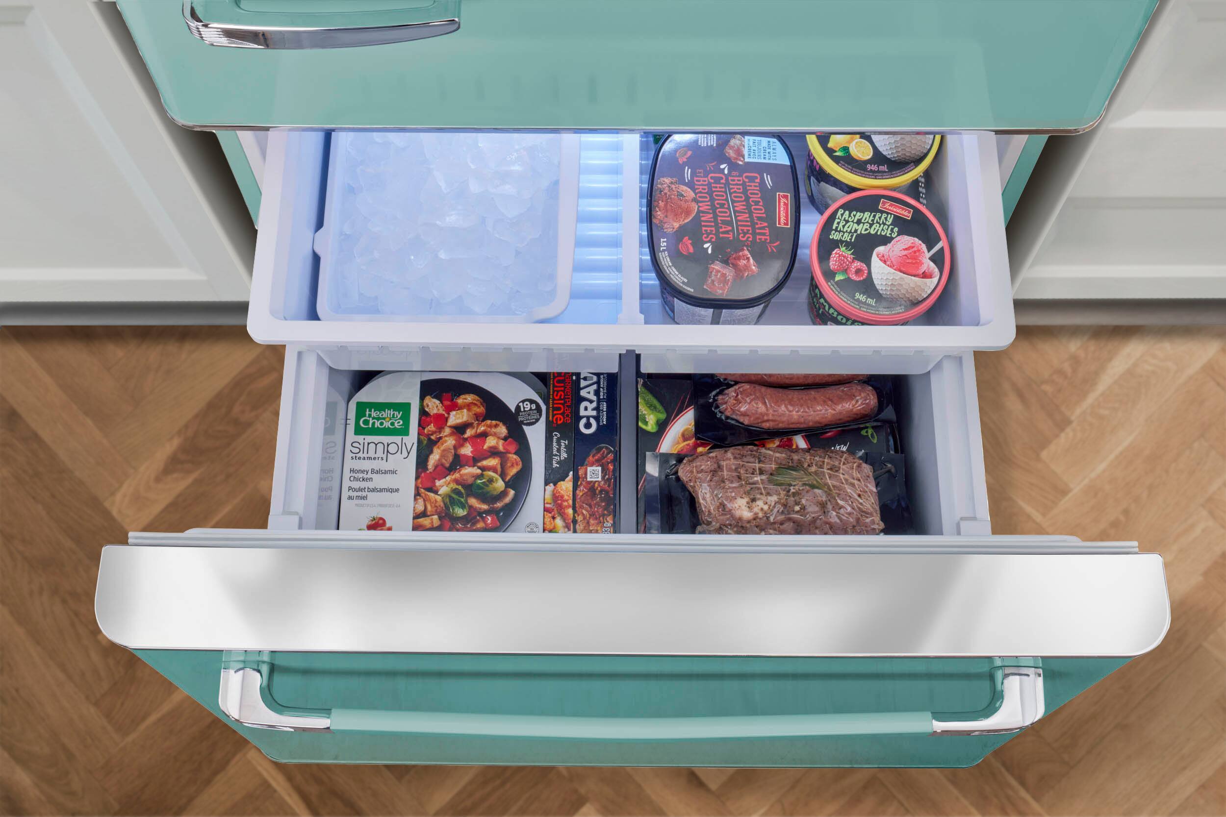 The image shows an open refrigerator with various food items inside. The refrigerator is filled with a variety of food, including a bowl of soup, a container of ice cream, and a container of yogurt. There is also a bottle of wine, a container of chicken, and a container of raspberry sorbet. The refrigerator is well-stocked, providing a variety of options for meals and snacks.