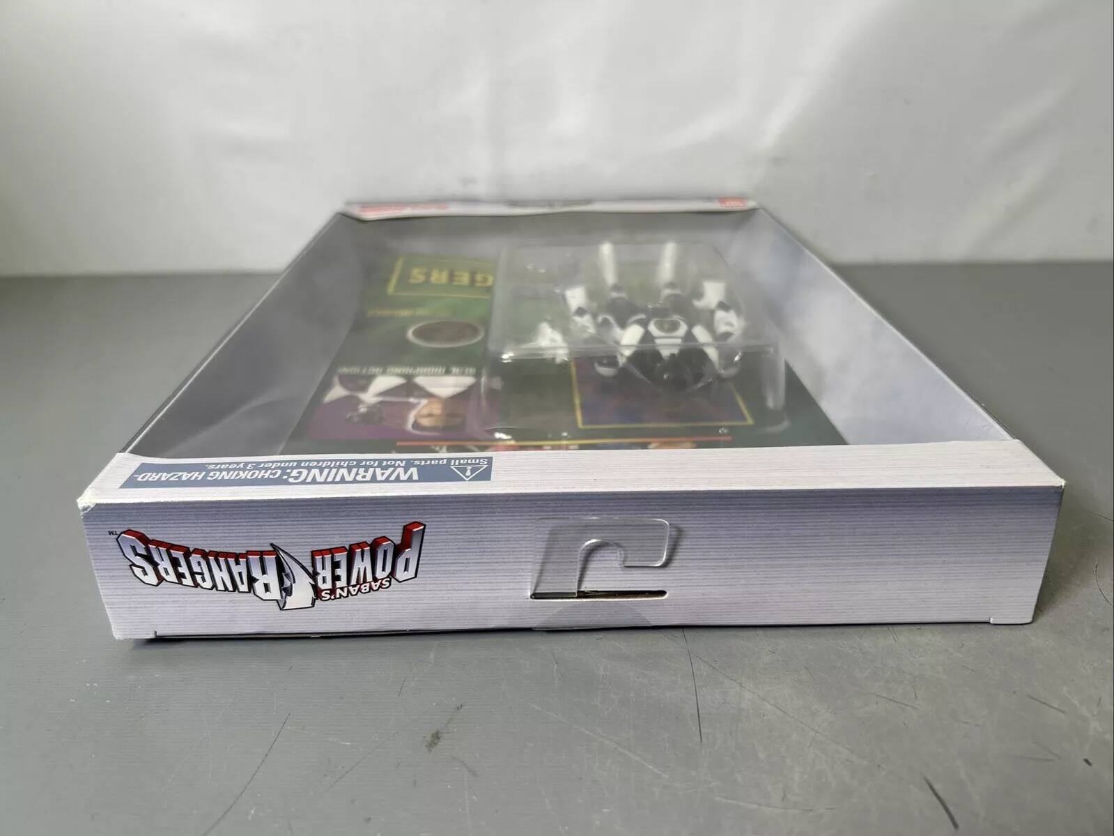 The text on the image reads: "GERS children 2022 202 parts. Small Ve4 E sapun HAZARD CHOKING WARNING: RANGERS POWER SABAN'S."