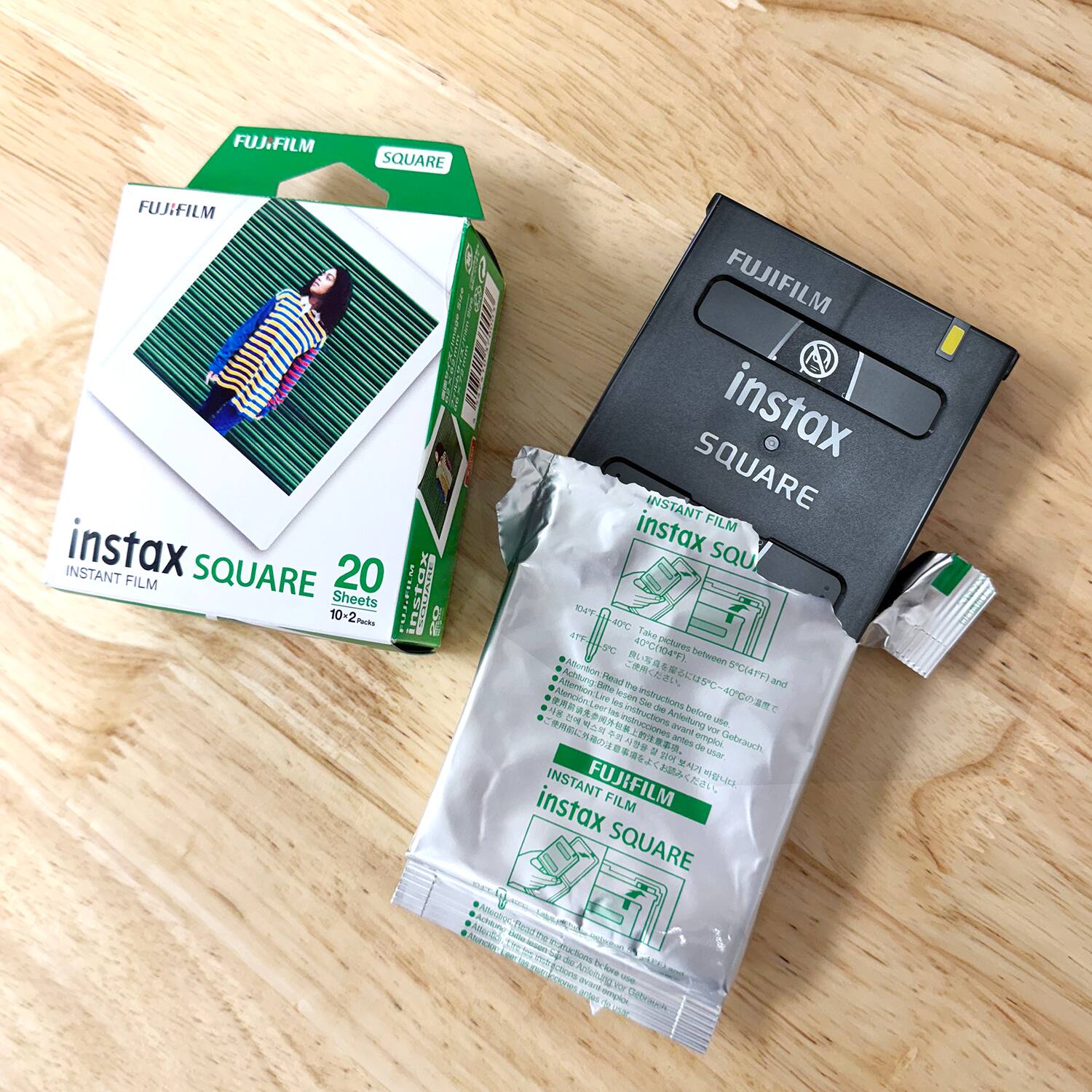 FUJIFILM SQUARE  
FUJIFILM AER INSTANT  
instax SQUARE 20 FILM  
10-2 Sheets  

FUJIFILM instax INSTANT SQUARE  
instax FILM SQUARE  
DH4Y 40C  
Take aC C(104F)  
vitues between Actoung Hand  
4 5C(4PF) and nemsoid.ere  
Hite me Aencion as aM the instructions  
- 2T E  
ies ULE belore  
Arietung ue  
E avant w  
aes emTECL Debrauch e  
M de 20 -er  
INSTANT FUJIFILM  
instax FILM SQUARE  
Aertc C 2 -o nactoe mm + de tu -O  
Ecton Artunang and Se  
FY NA - empice Debrsh  

FUJIFILM  
instax SQUARE  
20  
Sheets  
10-2 Packs  

FUJIFILM  
INSTANT FILM  
instax SQUARE  

FUJIFILM  
INSTANT FILM  
instax SQUARE