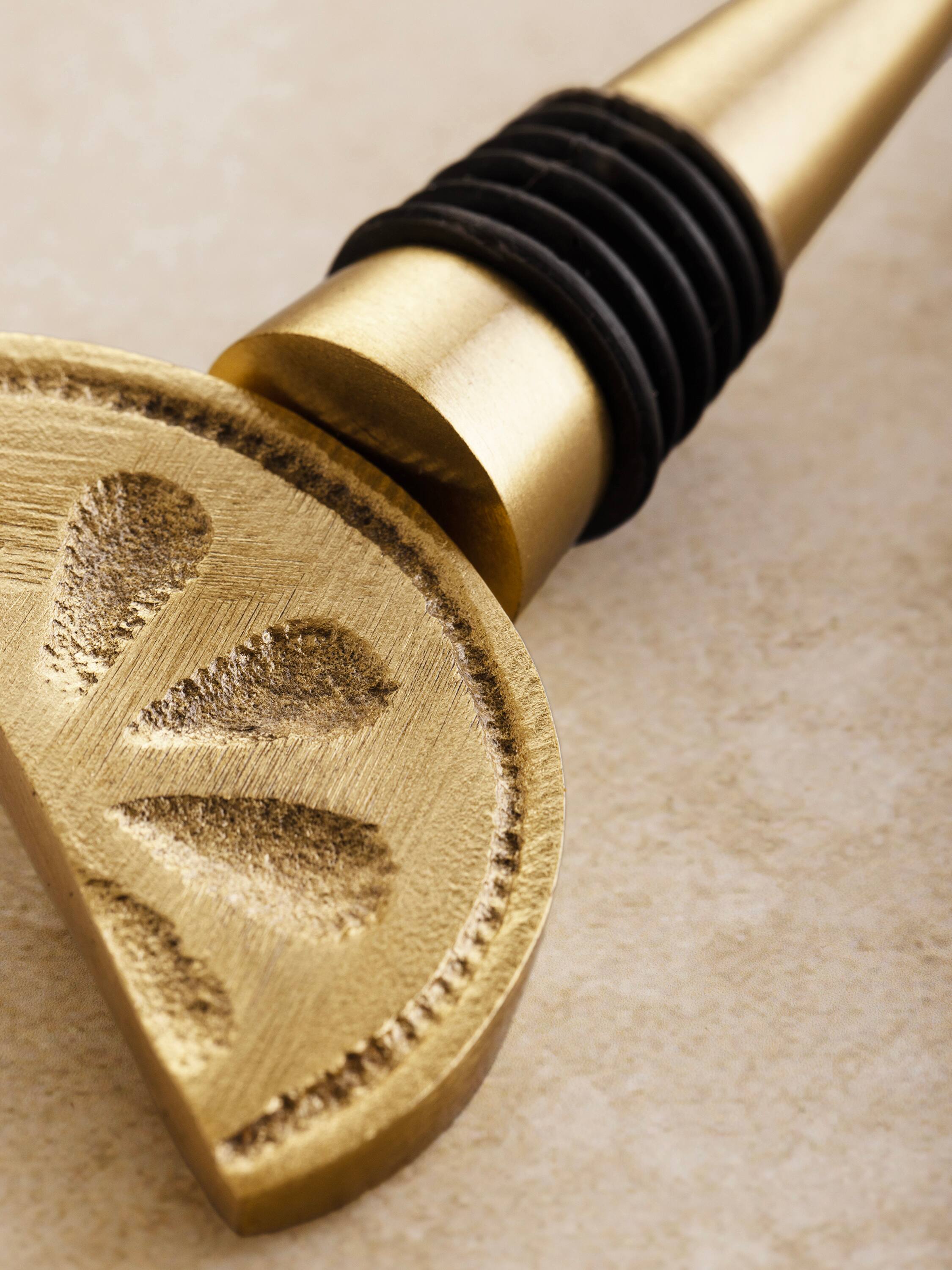 Left. GAURI KOHLI - Trellis Wine Bottle Stopper - Matte gold.