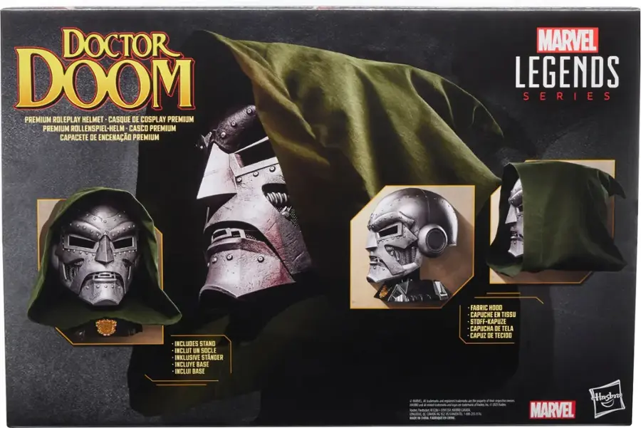 The image features a boxed set of Doctor Doom premium roleplay items from the Marvel Legends series. The set includes a helmet, a cape, and a stand. The helmet is made of fabric, and the cape is made of tissue. The stand is also included in the set, making it a complete and ready-to-use costume for fans of the Marvel universe.