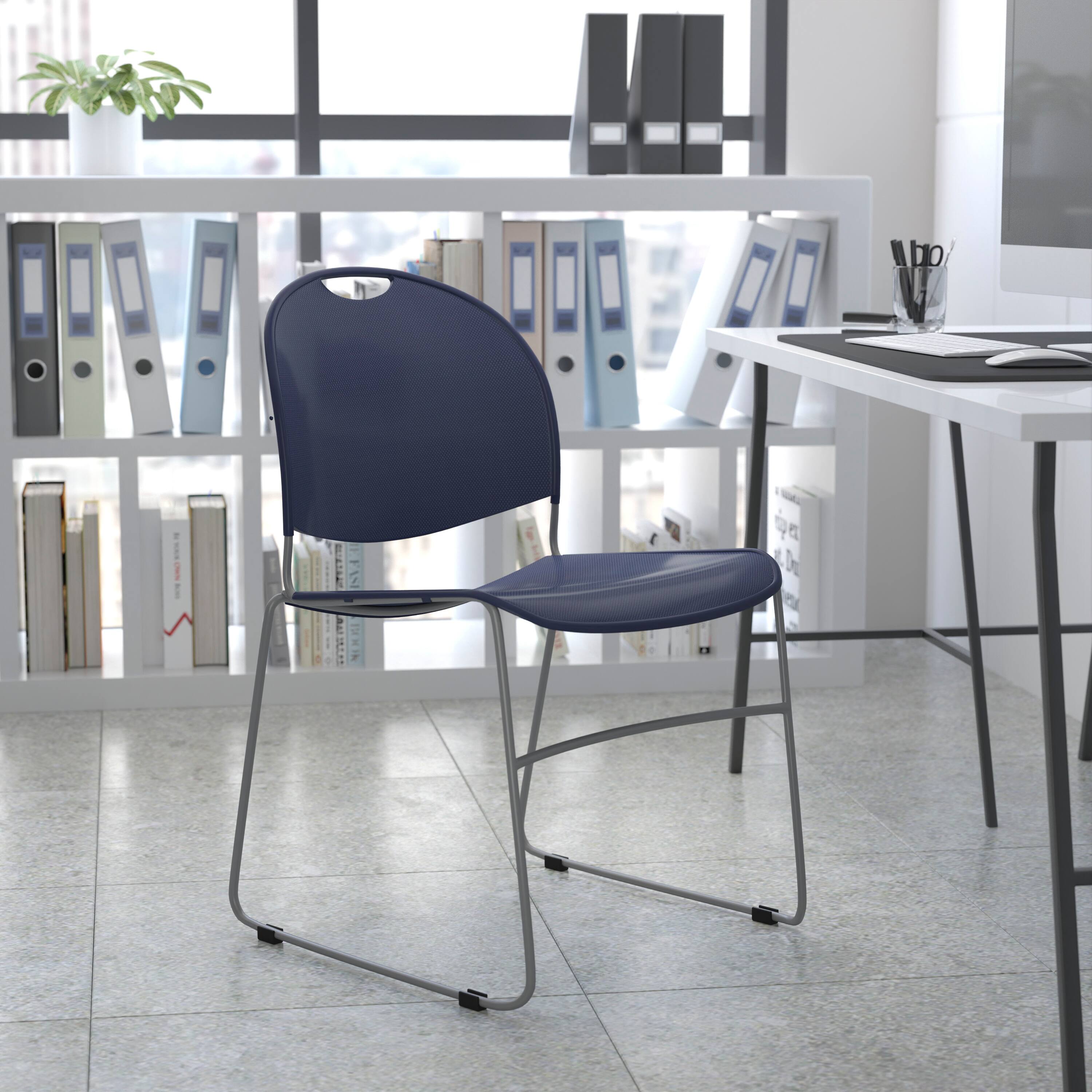 Angle. Flash Furniture - HERCULES Series 880 lb. Capacity Navy Ultra-Compact Stack Chair with Silver Powder Coated Frame - Blue.