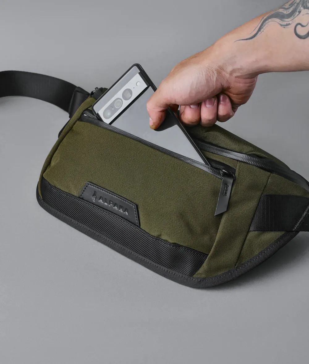 Alt View 1. ALPAKA - Sling Bag Bag for Men, Fits iPad Mini & Switch OLED, Hidden Rear Pocket, Magnetic Buckle, YKK AquaGuard Zippers - Army Green Axoflux 300D.
