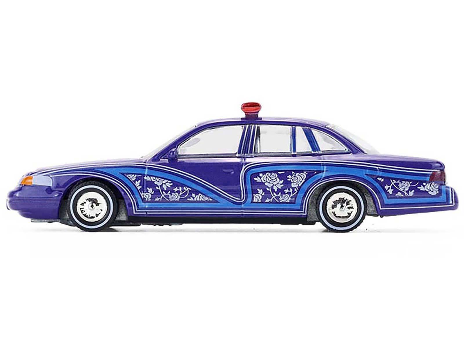 Left. Greenlight - 1992 Ford Crown Victoria Lowrider Blue Graphics Lightbar California Lowriders Series 7 1/64 Diecast Model Car - Blue.