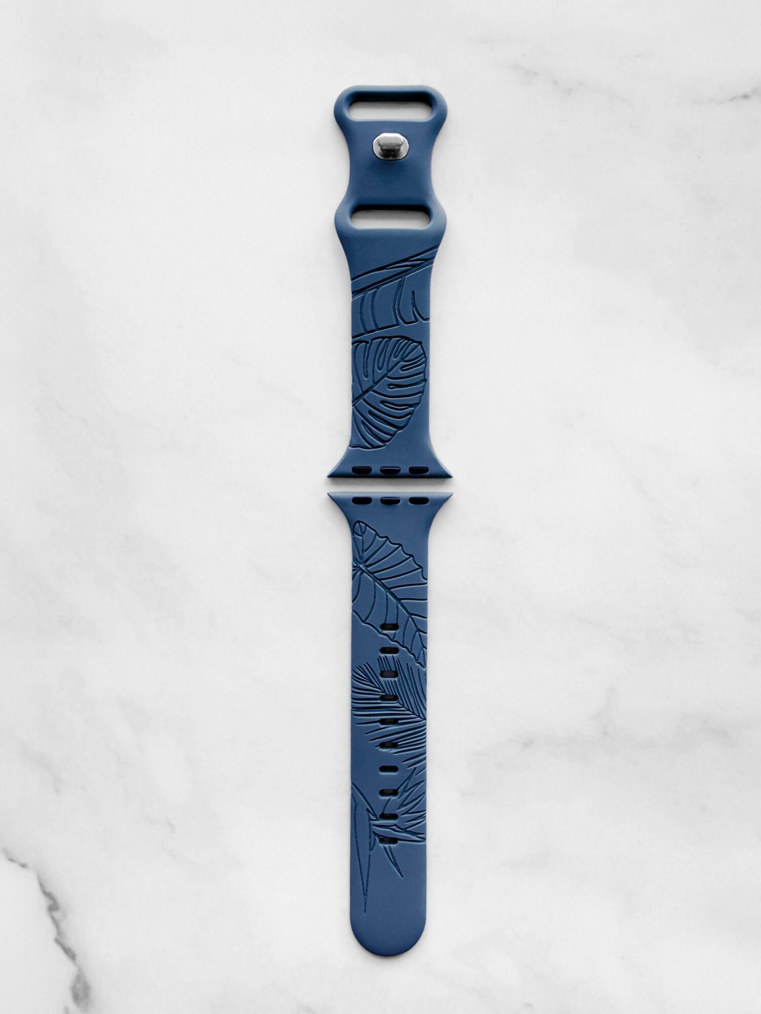 Angle. ROXTRO - Dusty Denim Tropical Engraved Silicone Watch Band Apple Watch Compatible SMALL WATCH 38/40/41mm & (42mm Series 10 & Up) - Dusty Denim Blue.