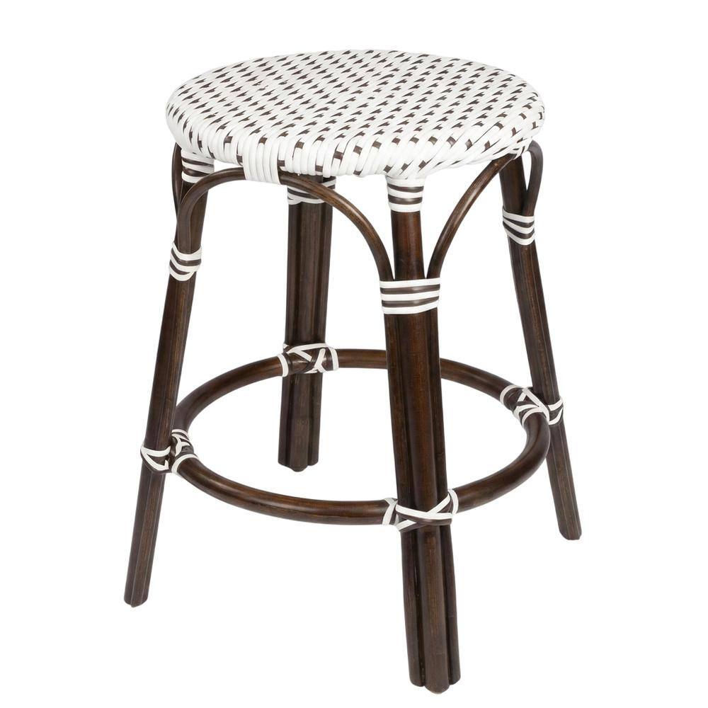 Angle. Butler Specialty - Tobias Rattan Round 24" Counter Stool - White And Brown Dot.