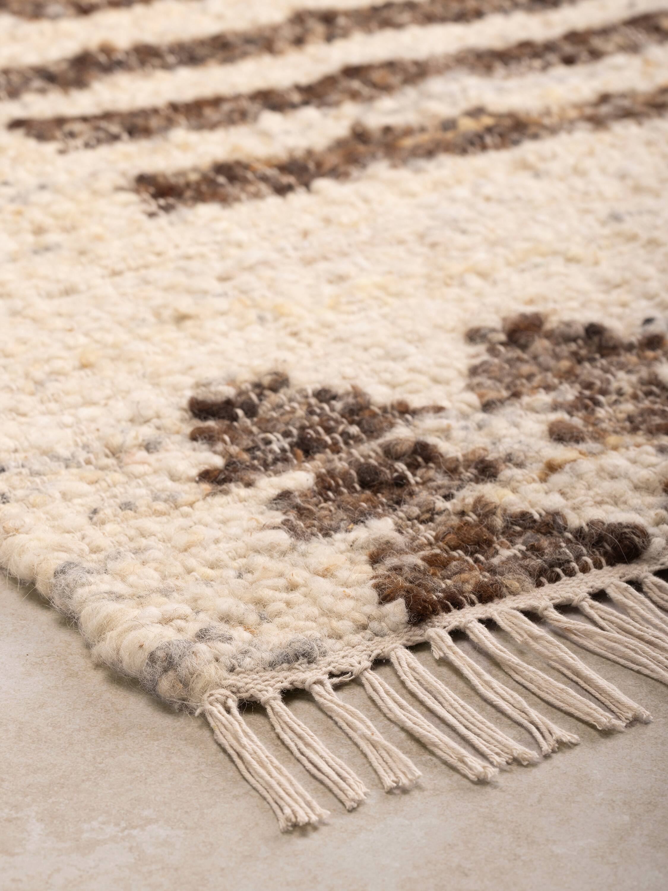 Left. GAURI KOHLI - Baltimore Rug - Shades of beige and brown.