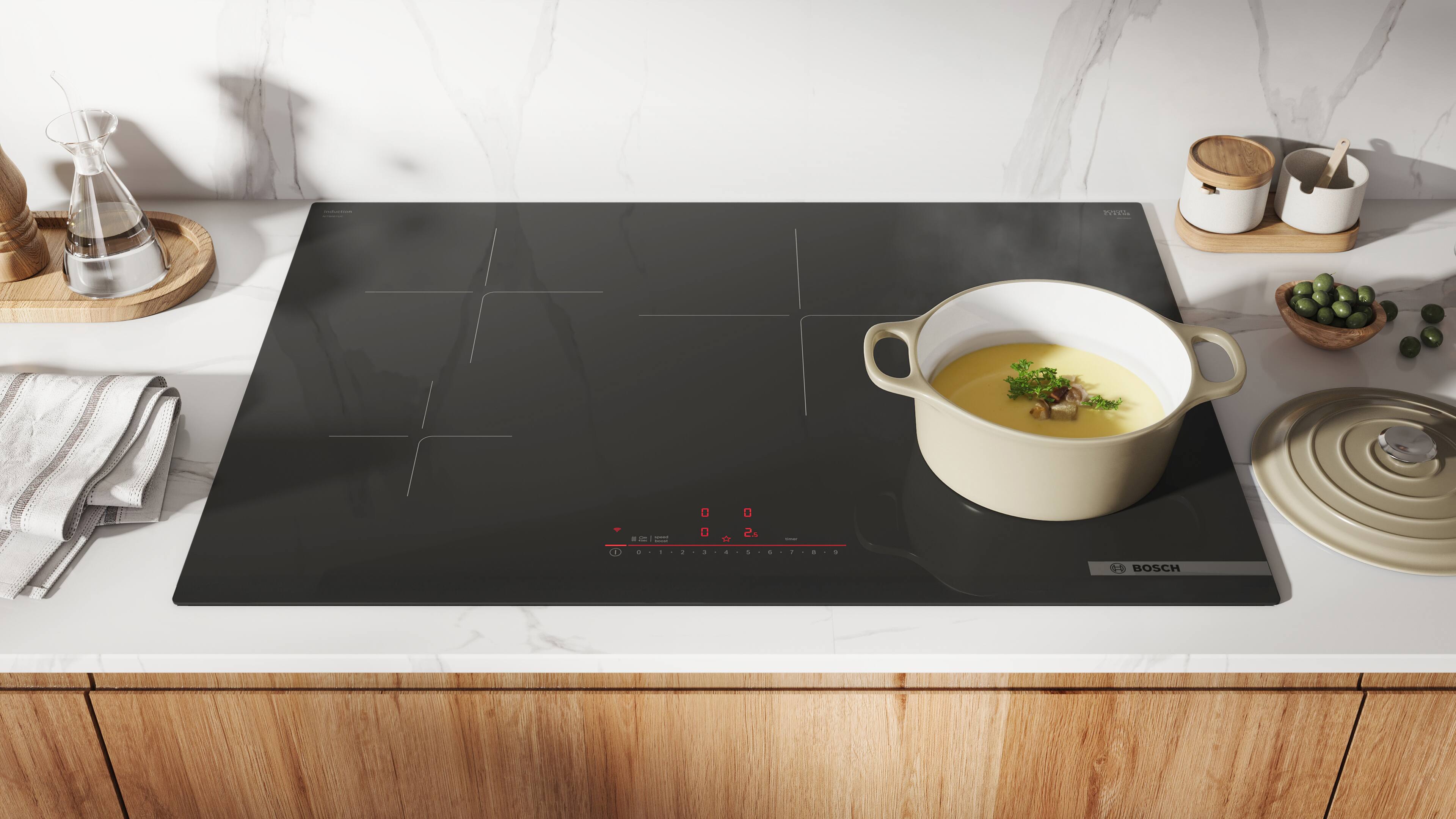 The text on the image is:

- "BOSCH" (on the induction cooktop)
- "0" (temperature display on the cooktop)
- "0" (timer display on the cooktop)
- "1" (power level display on the cooktop)
- "2" (power level display on the cooktop)
- "3" (power level display on the cooktop)
- "4" (power level display on the cooktop)
- "5" (power level display on the cooktop)
- "6" (power level display on the cooktop)
- "7" (power level display on the cooktop)
- "8" (power level display on the cooktop)
- "9" (power level display on the cooktop)
- "10" (power level display on the cooktop)
- "11" (power level display on the cooktop)
- "12" (power level display on the cooktop)
- "13" (power level display on the cooktop)
- "14" (power level display on the cooktop)
- "15" (power level display on the cooktop)
- "16" (power level display on the
