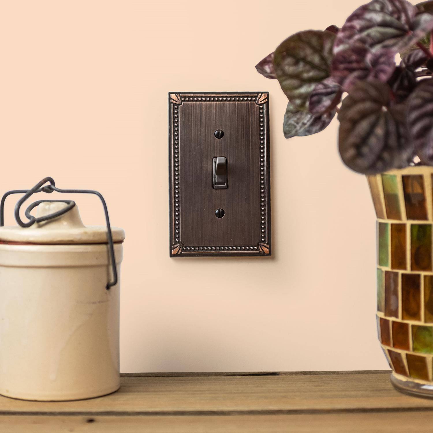 Left. AMERELLE - Amerelle Imperial Bead Aged Bronze 2 gang Die-Cast Metal Toggle Wall Plate 1 pk - Bronze.