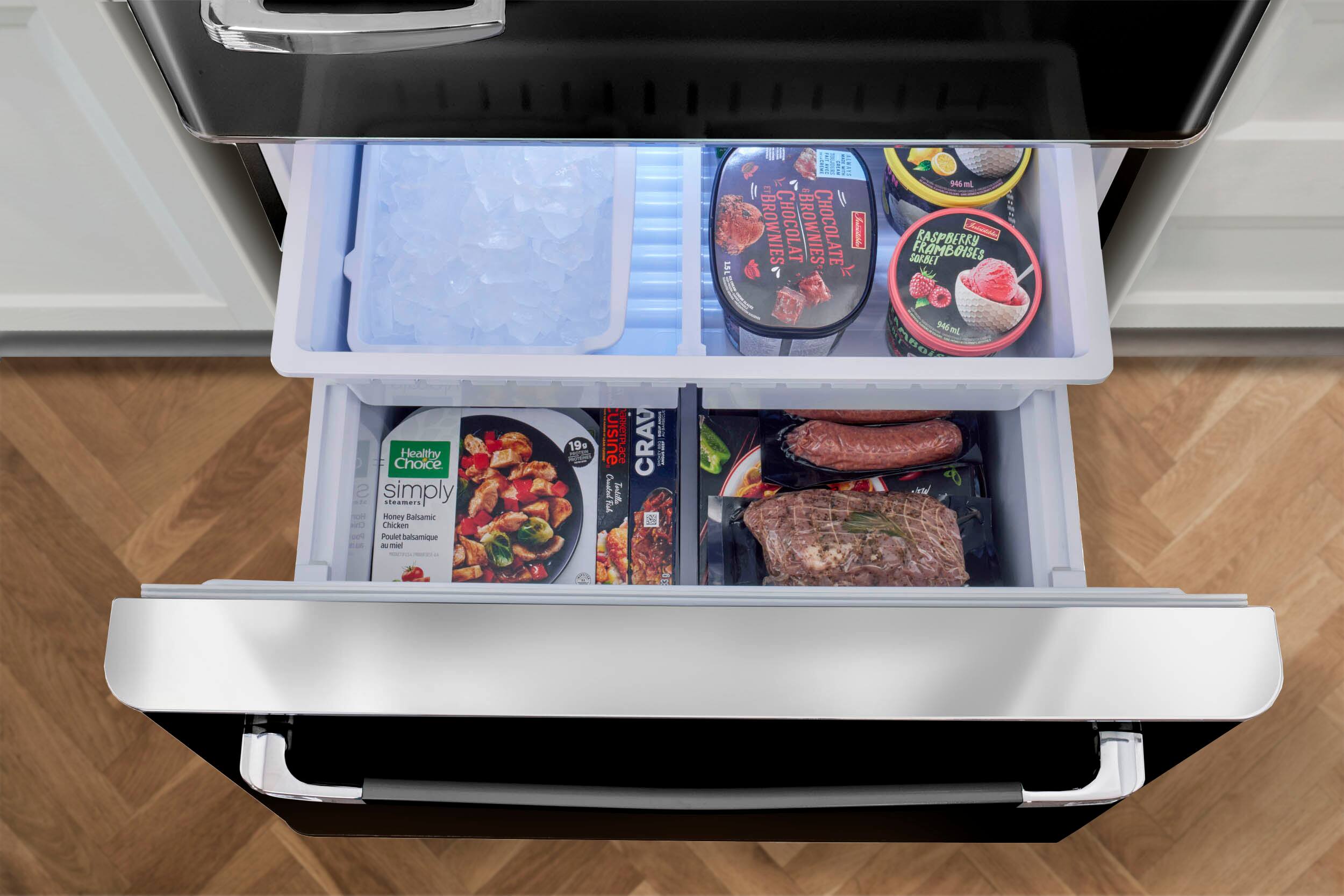 The image shows a refrigerator with its door open, revealing a variety of food items stored in the door compartments. There are several bowls containing different types of food, such as chicken, raspberry sorbet, and other items. The refrigerator is filled with a variety of foods, making it a well-stocked kitchen.