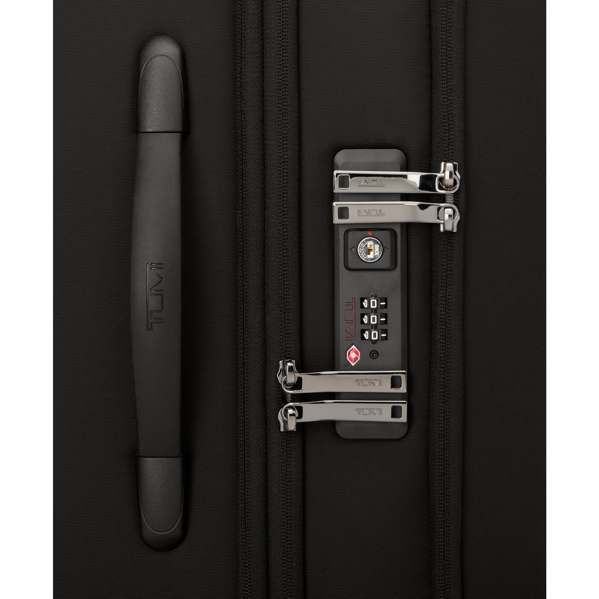 The text on the image appears to be a combination lock with the brand name "TUMI" on it. The lock has a series of numbers and symbols on it. Here is the corrected and grouped text:

- TUMI
- 000-000
- TUMI
- TUMI

The lock is part of a black bag or luggage.