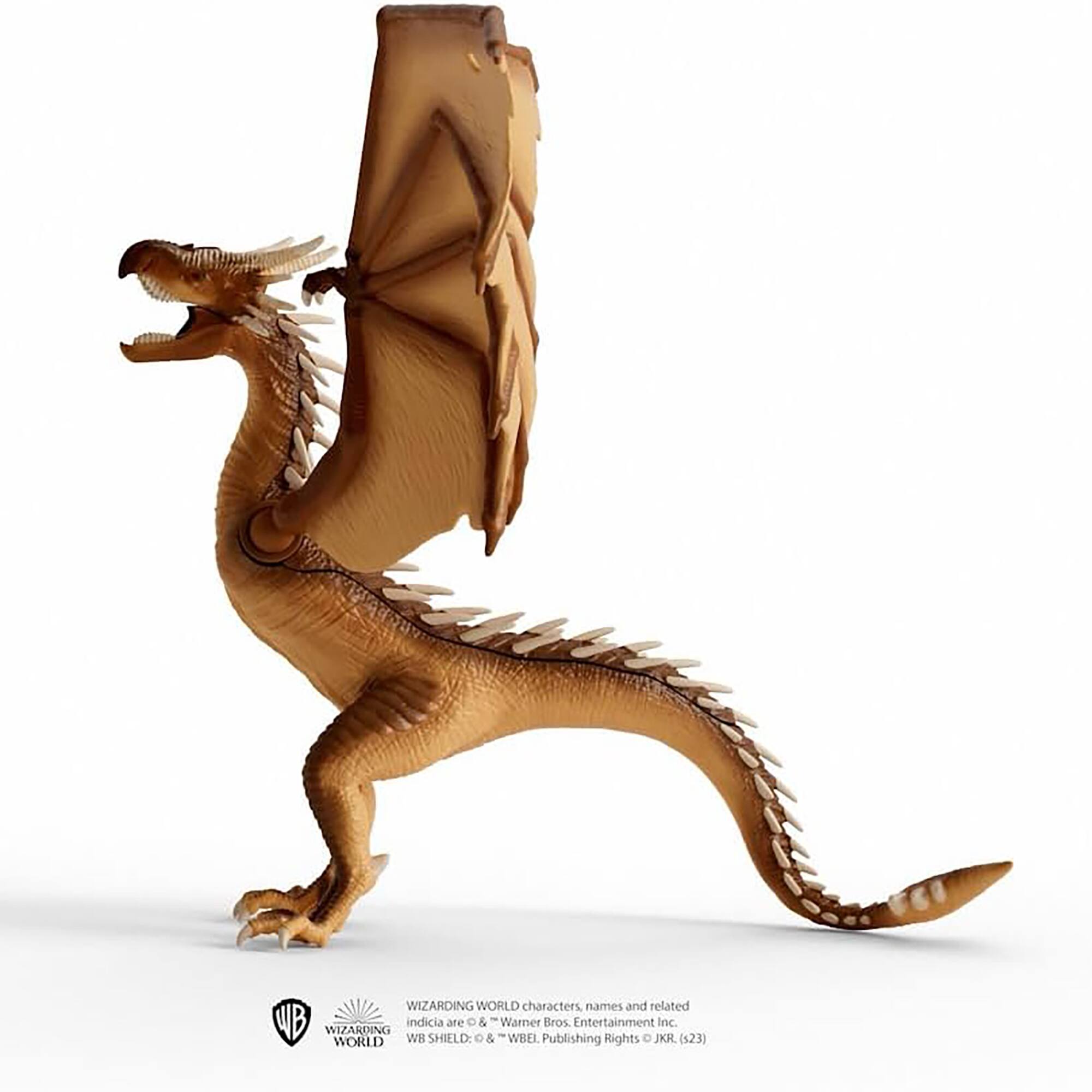 The image features a dragon model with a large wing, which is part of the Wizarding World characters, names, and related Warner Bros Entertainment Inc. indicia. The dragon model is displayed on a white background, and the Wizarding World shield is also present, along with the copyright information for JKR (s23).