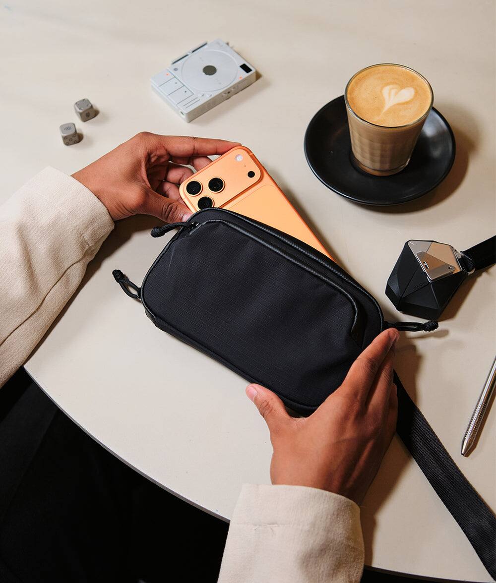 Alt View 7. ALPAKA - Bravo Passport Pouch Sling Bag for Men, Passport Holder for Travel, Fits iPhone Pro Max, RFID, AirTag Sleeve - Black Axoflux 210D.