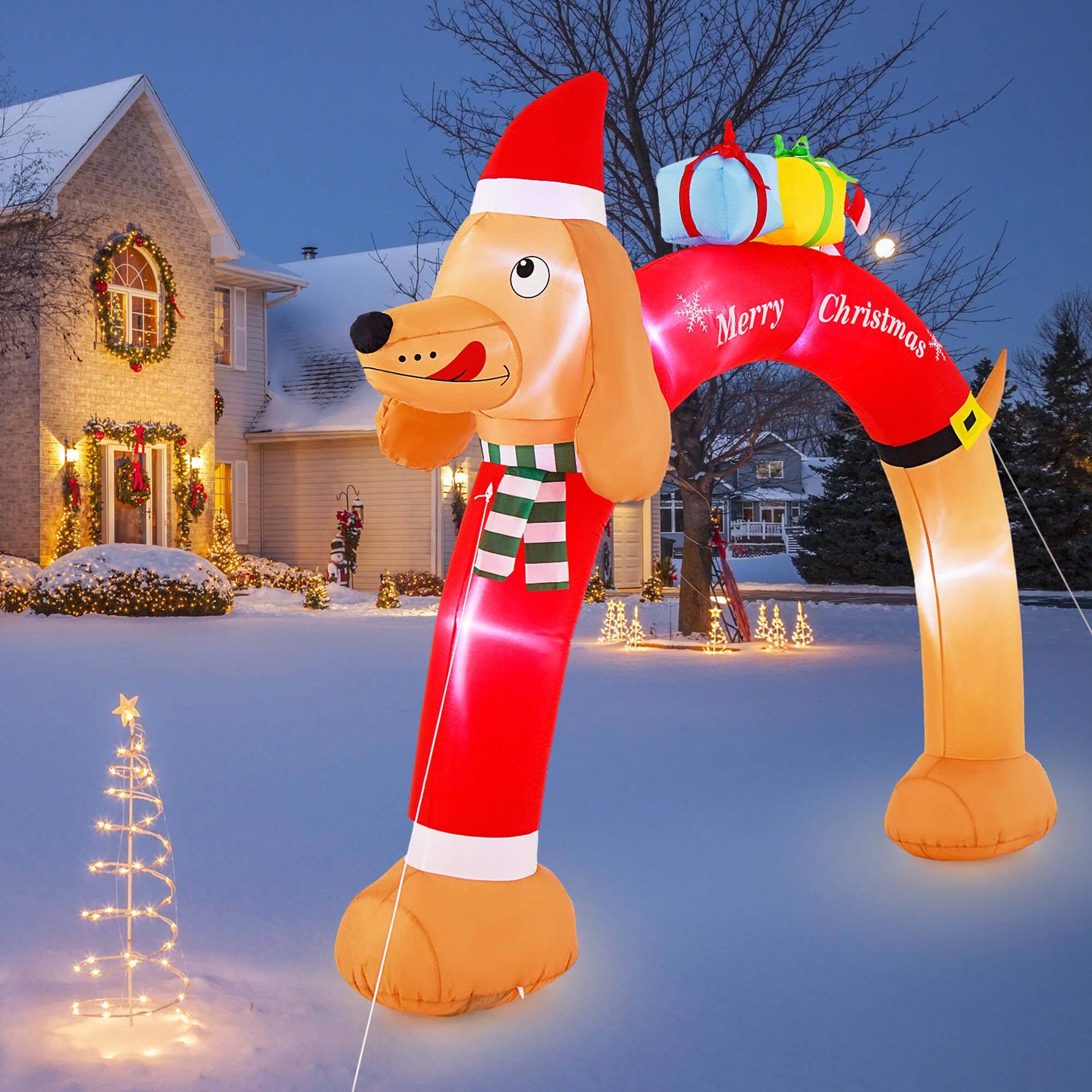 The text "Merry Christmas" is displayed on the inflatable dog's red and white scarf.