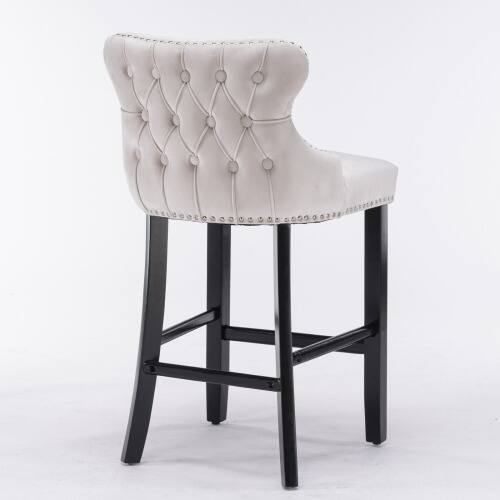 Left. LUCKY ONE - Assembled Wing-Back Velvet Bar Stool Set of 2 Button Tufted Wood Legs Chrome Nailhead Trim - Beige.