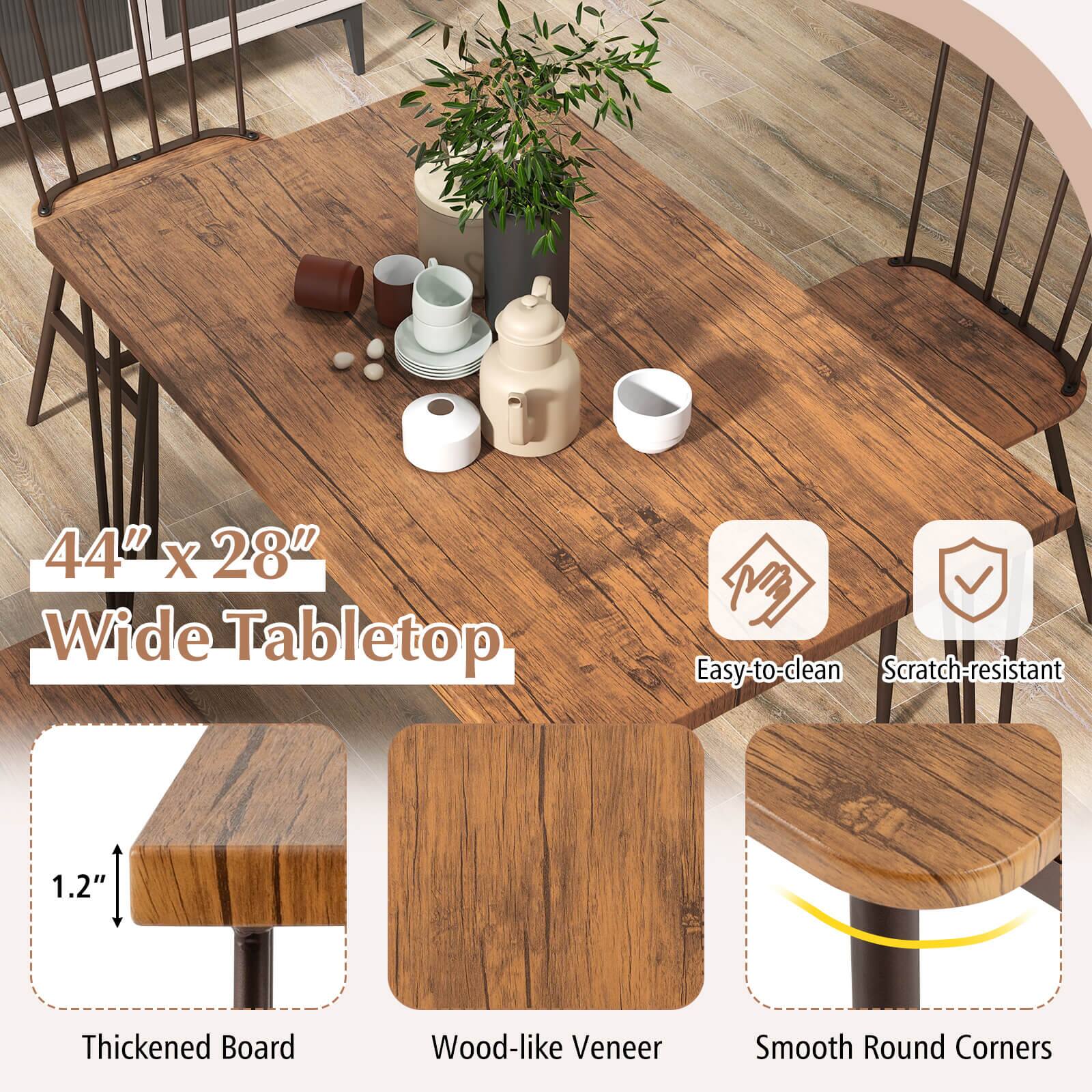The image features a wooden dining table with a vase of flowers on top. The table is accompanied by chairs and has a 44" x 28" wide tabletop. The tabletop is made of easy-to-clean, scratch-resistant material, and it has a thickness of 1.2". The table is designed with wood-like veneer and smooth round corners, making it an attractive and functional piece of furniture.