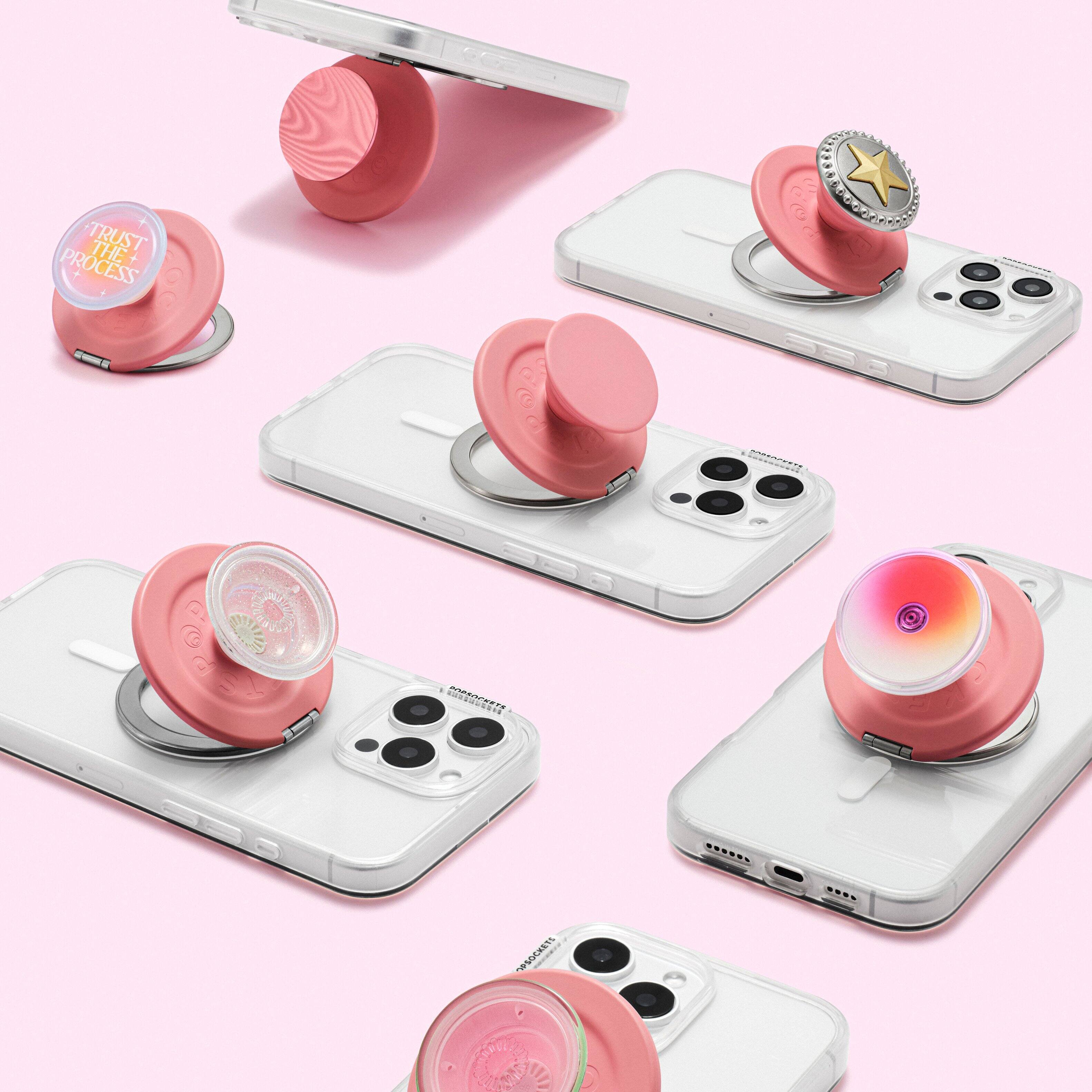 The image features a collection of six different pink cell phone cases, each with a unique design. The cases are placed on top of a white cell phone, showcasing their compatibility with the device. The cases are arranged in a visually appealing manner, with some cases placed closer to the camera and others further away. The overall scene emphasizes the variety and creativity of the cell phone cases.