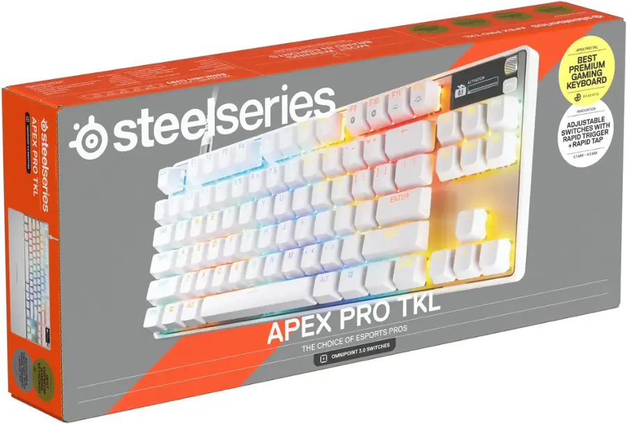 The image features a close-up of a white and blue keyboard, which is part of the APEX Pro TKL series by Steelseries. The keyboard is designed with a focus on ergonomics and comfort, making it an ideal choice for gamers and professionals. The keys are illuminated with a rainbow of colors, adding a visually appealing touch to the keyboard. The APEX Pro TKL keyboard is equipped with high-quality switches, rapid adjustable DPI, and a rapid trigger for an enhanced gaming experience.