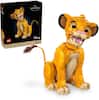 The Lion King Lego Disney set includes 1445 pieces and is recommended for ages 18+. The set features a yellow and brown lion, as well as a box with a picture of the lion on it.