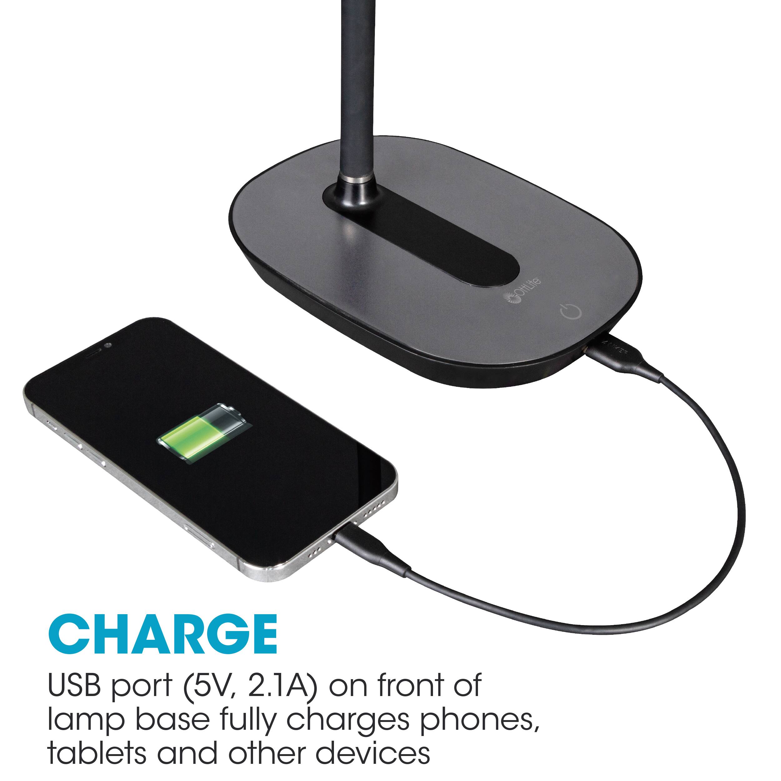 The image features a black stand with a USB port on the front, which is designed to charge phones, tablets, and other devices. The stand is connected to a lamp base, which provides a convenient and portable charging solution. The USB port is capable of delivering a voltage of 5V and a current of 2.1A, ensuring that devices are fully charged. The stand is suitable for charging various devices, including phones, tablets, and other electronic devices.