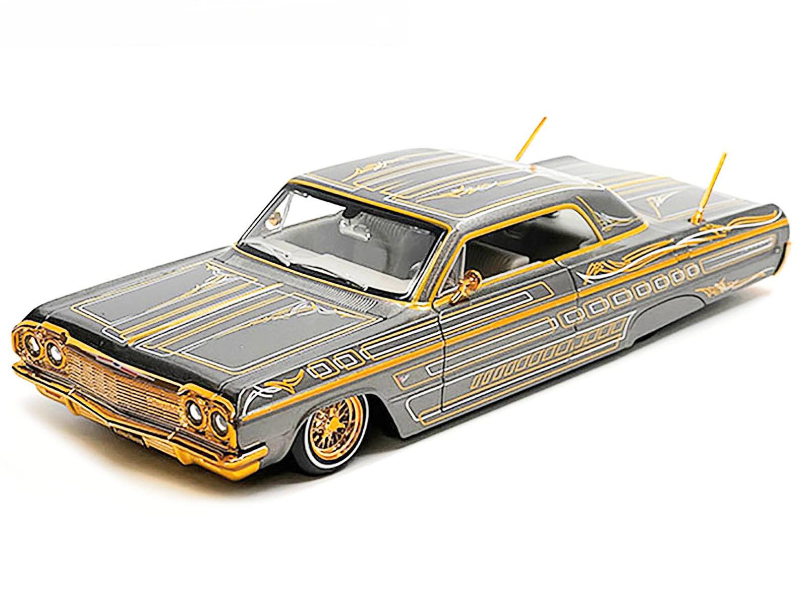 Left. Maisto - 1964 Chevrolet Impala SS Lowrider Gray Metallic with Gold Graphics "Lowriders" "Maisto Design" Series 1/26 - Gray Metallic with Gold.