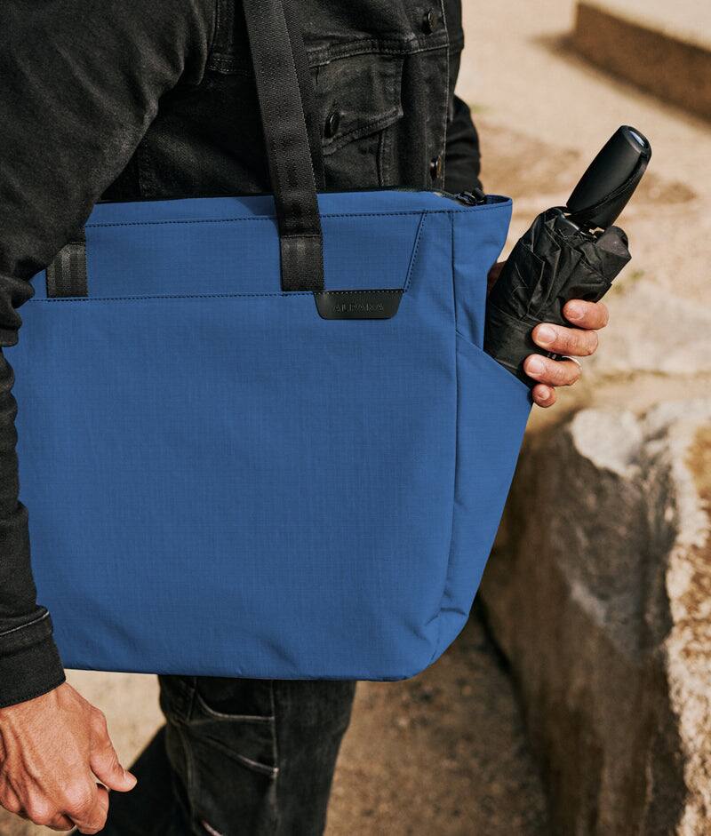 Alt View 2. ALPAKA - Metro Tote Laptop Tote Bag for Work, Work Tote Fits 16" MacBook Pro, Side Bottle Pocket, Weather-Resistant, Key Tether - Blue Axoflux 210D.