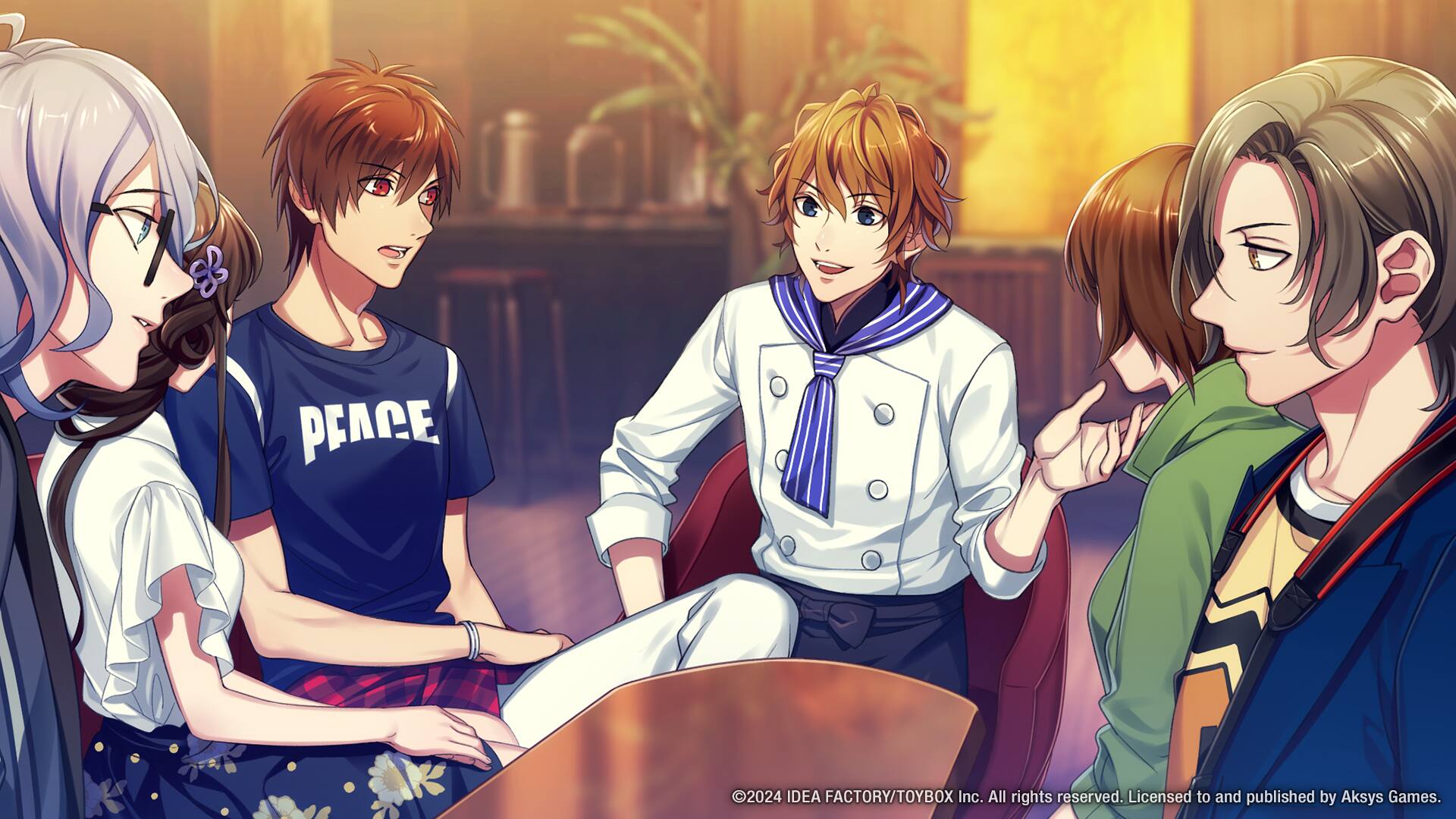 The image shows a group of people sitting around a table, engaged in conversation. There are five people in total, with one person on the left side of the table, two people in the middle, and two people on the right side. The table appears to be a dining table, and there are two potted plants in the room, one near the left side of the table and the other near the right side. The people in the image seem to be enjoying each other's company and having a good time.