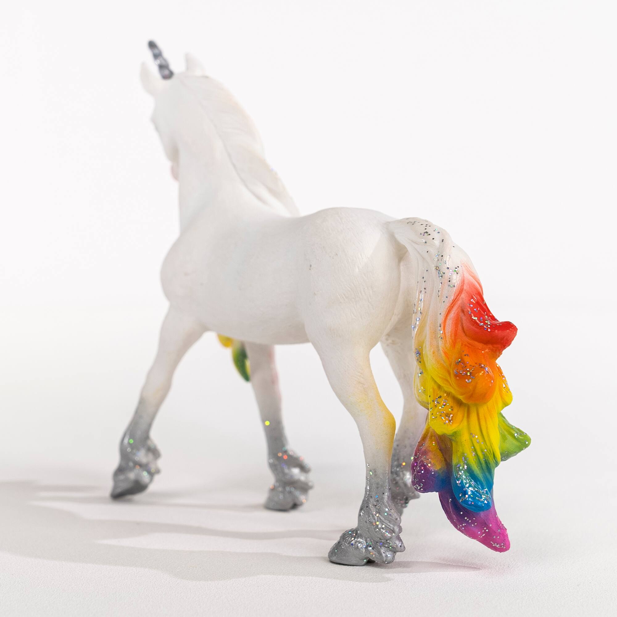 Left. Schleich - Bayala: Rainbow Love Unicorn Stallion.