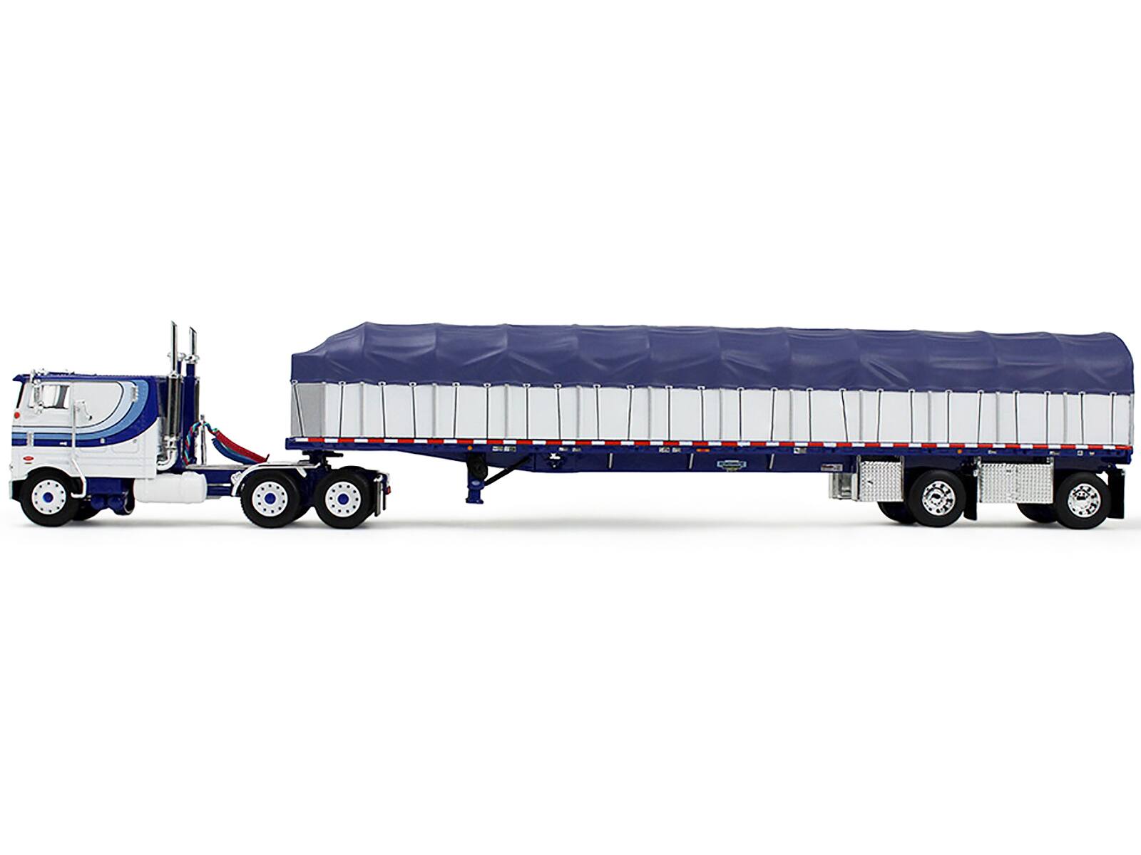 Left. First Gear - Peterbilt 352 COE 110" Sleeper and 53’ Wilson Roadbrute Flatbed Trailer with Covered Wagon White with Blue Stripes 1/64 - White and Blue.