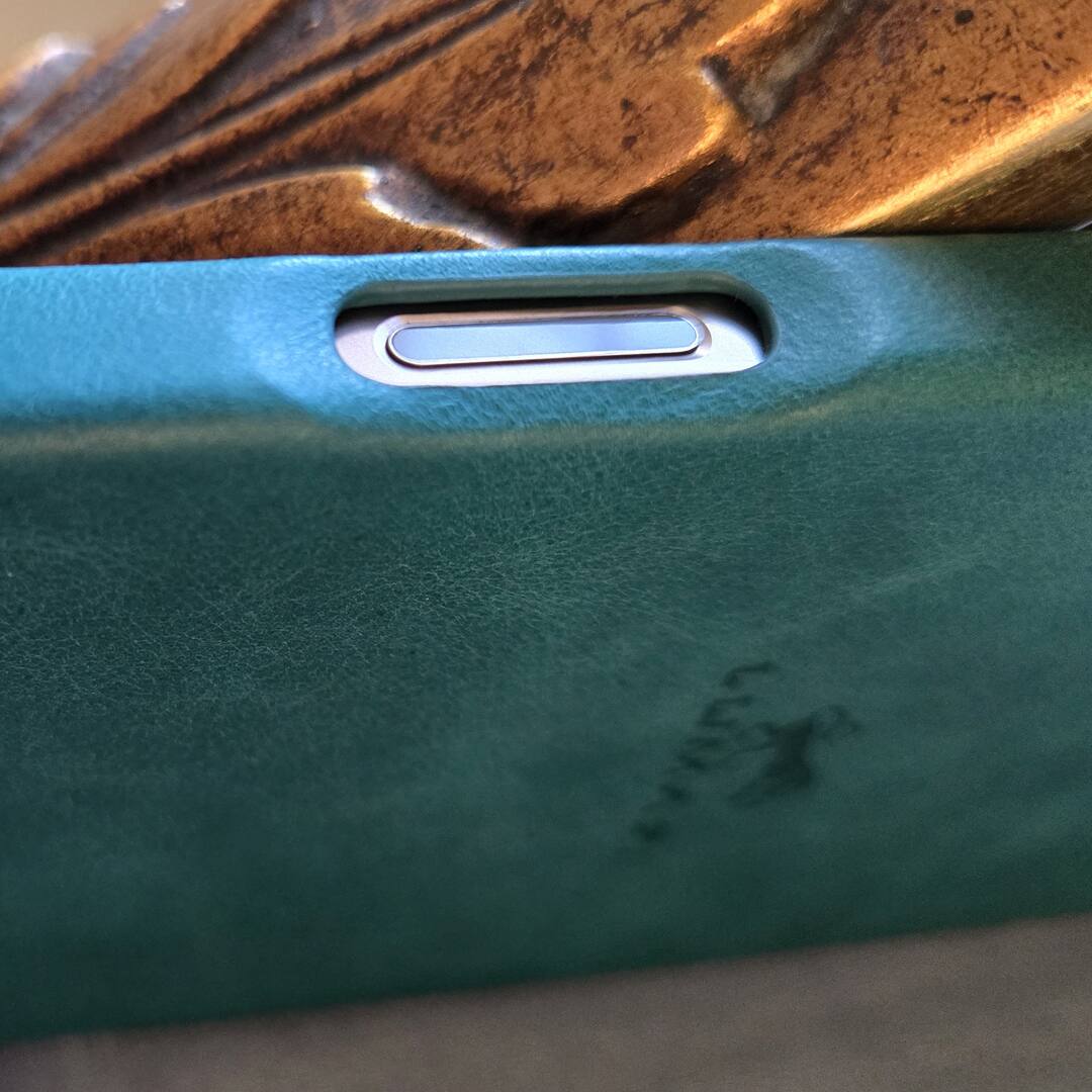 Left. LUMAZI - Handmade, Full Grain Leather, MagSafe iPhone 16 Pro Case - Pharaonic Turquoise.