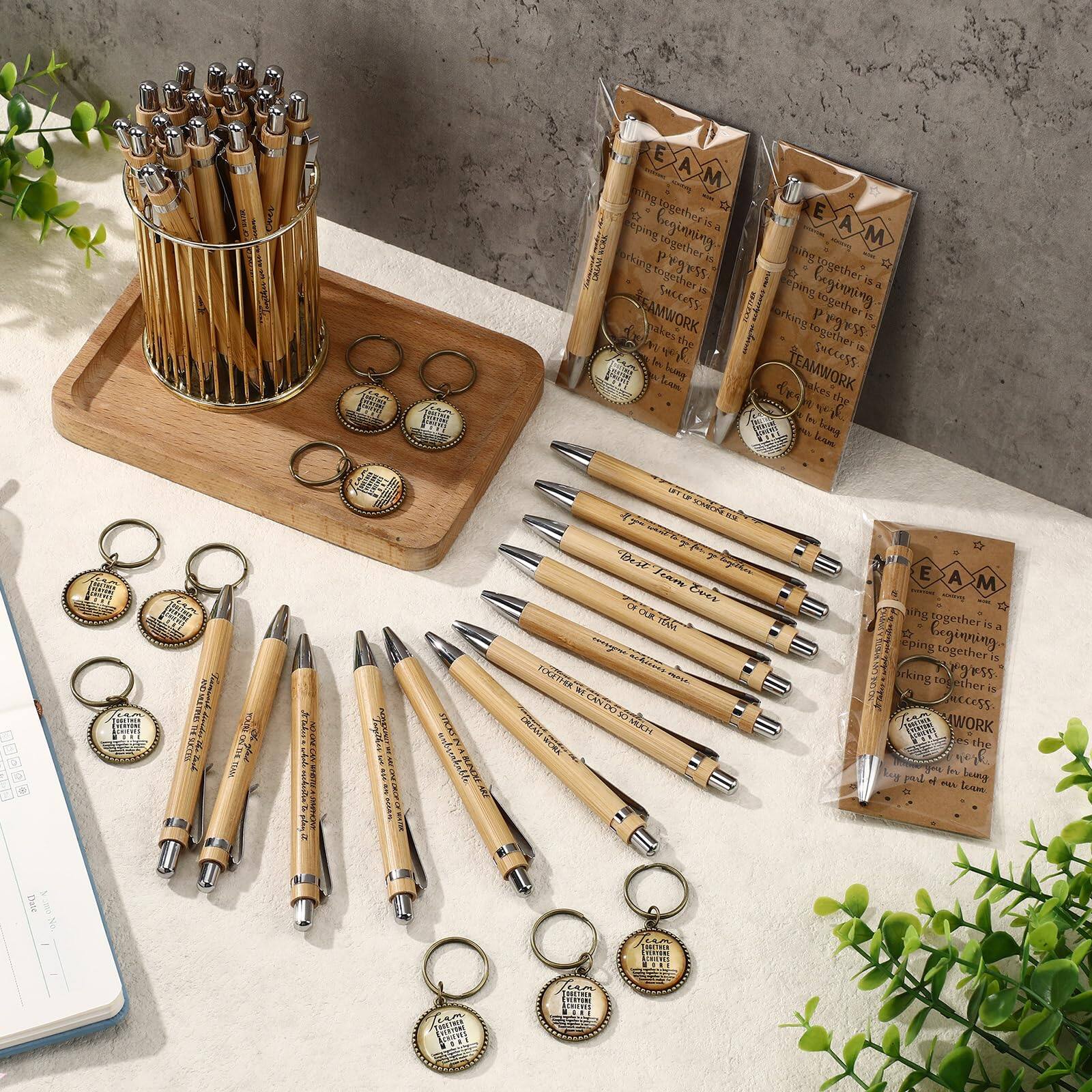 Sure, here is the corrected and grouped text from the image:

**On the Pens:**
- "TEAM"
- "TEAMWORK makes the dream work"
- "TEAMWORK makes the dream work"
- "TEAMWORK makes the dream work"
- "TEAMWORK makes the dream work"
- "TEAMWORK makes the dream work"
- "TEAMWORK makes the dream work"
- "TEAMWORK makes the dream work"
- "TEAMWORK makes the dream work"
- "TEAMWORK makes the dream work"

**On the Keychains:**
- "TEAM"
- "TEAMWORK makes the dream work"
- "TEAMWORK makes the dream work"
- "TEAMWORK makes the dream work"
- "TEAMWORK makes the dream work"
- "TEAMWORK makes the dream work"
- "TEAMWORK makes the dream work"
- "TEAMWORK makes the dream work"

**On the Packaging:**
- "TEAM"
- "Working together is progress"
- "Progressing together is success"
- "Success is teamwork"
- "TEAMWORK makes the dream work"
- "TEAMWORK makes the dream work"
- "TEAMWORK makes the dream work"
- "TEAMWORK makes the dream work"

**On the Notebook:**
- "Date"
-