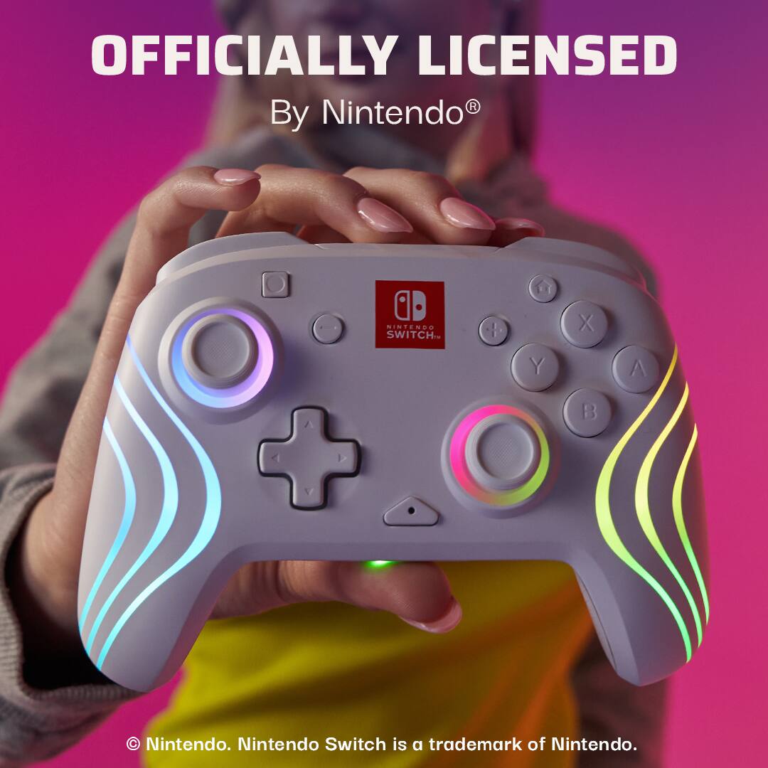 The image features a woman holding a Nintendo Switch controller, which is officially licensed by Nintendo. The controller has a unique design with a rainbow pattern and is specifically designed for the Nintendo Switch gaming system. The controller is being held in the woman's hand, showcasing its design and functionality.