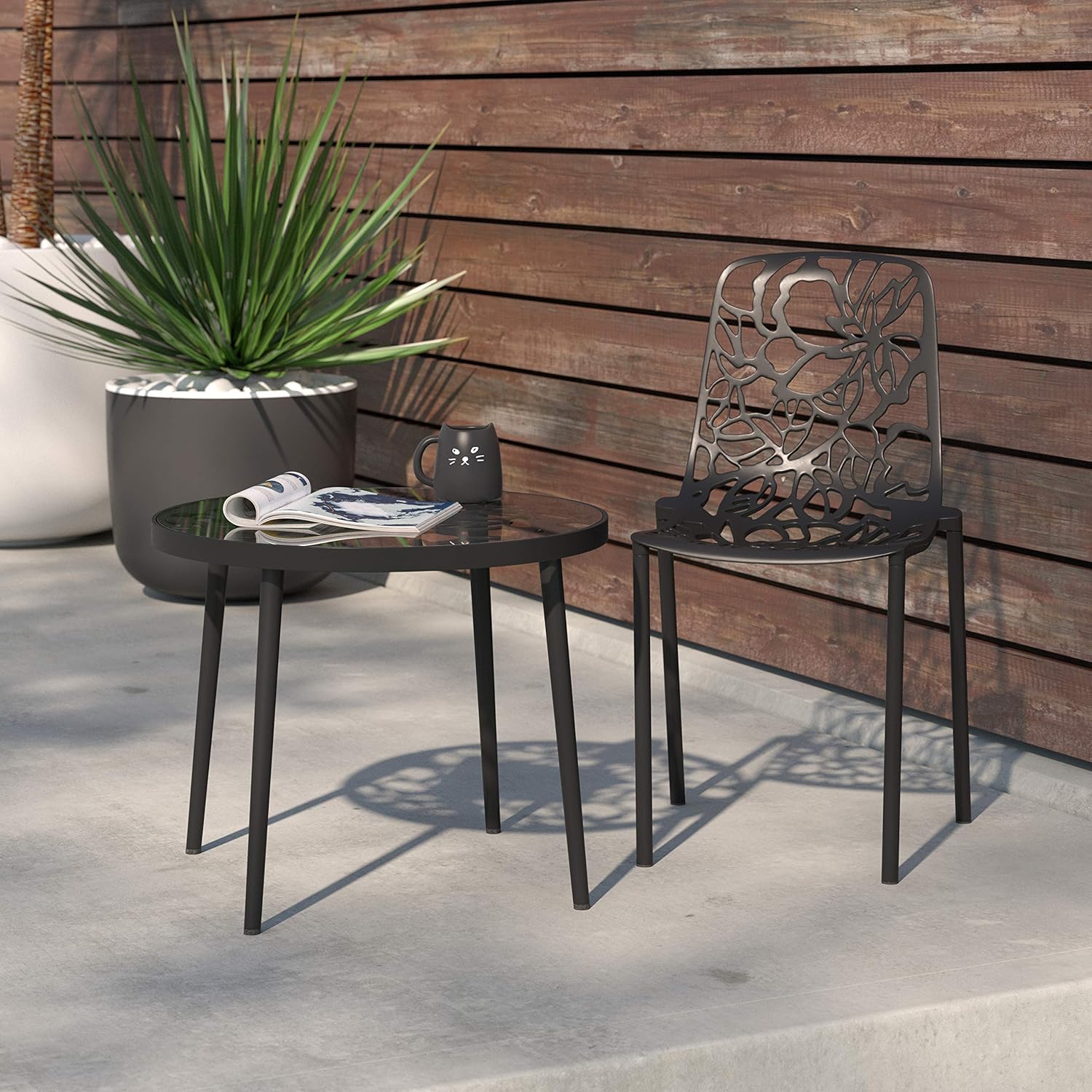 Angle. LeisureMod - Devon Stackable Aluminum Dining Chair, Modern Floral Cutout Indoor/Outdoor Patio Chair - Fully Assembled - Black.
