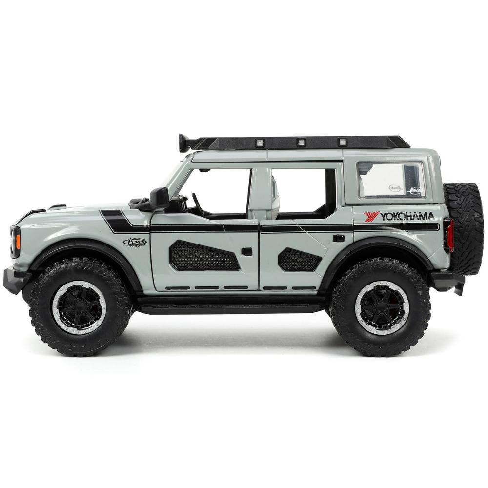 Left. Jada - 2021 Ford Bronco Gray with Black Stripes with Roof Rack "Own the Night" "Just Trucks" Series 1/24 - Gray and Black Stripes.