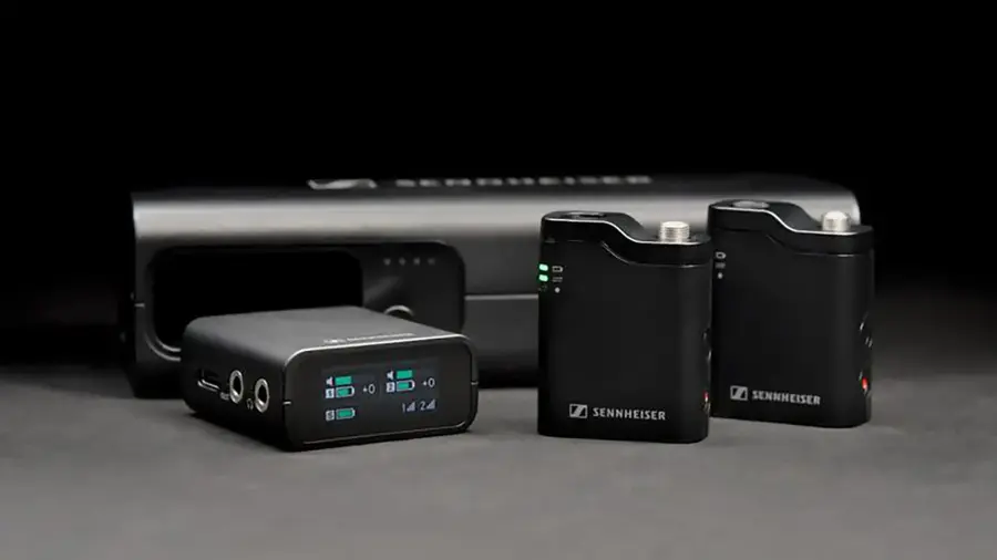 The image features a collection of Sennheiser electronic devices, including a microphone and a speaker. There are four Sennheiser devices in total, with one of them being a microphone. The devices are placed on a table, showcasing their compact and sleek design.