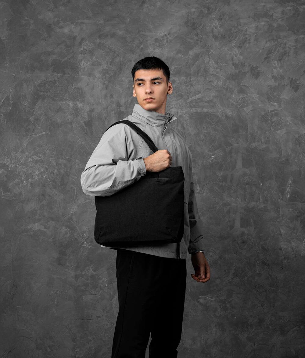 Angle. ALPAKA - Flight Tote (M) Laptop Tote Bag for Work, Tote Bag Fits 14" MacBook Pro, Water Bottle Pocket, Luggage Pass-Through - Black Axoflux 400D.