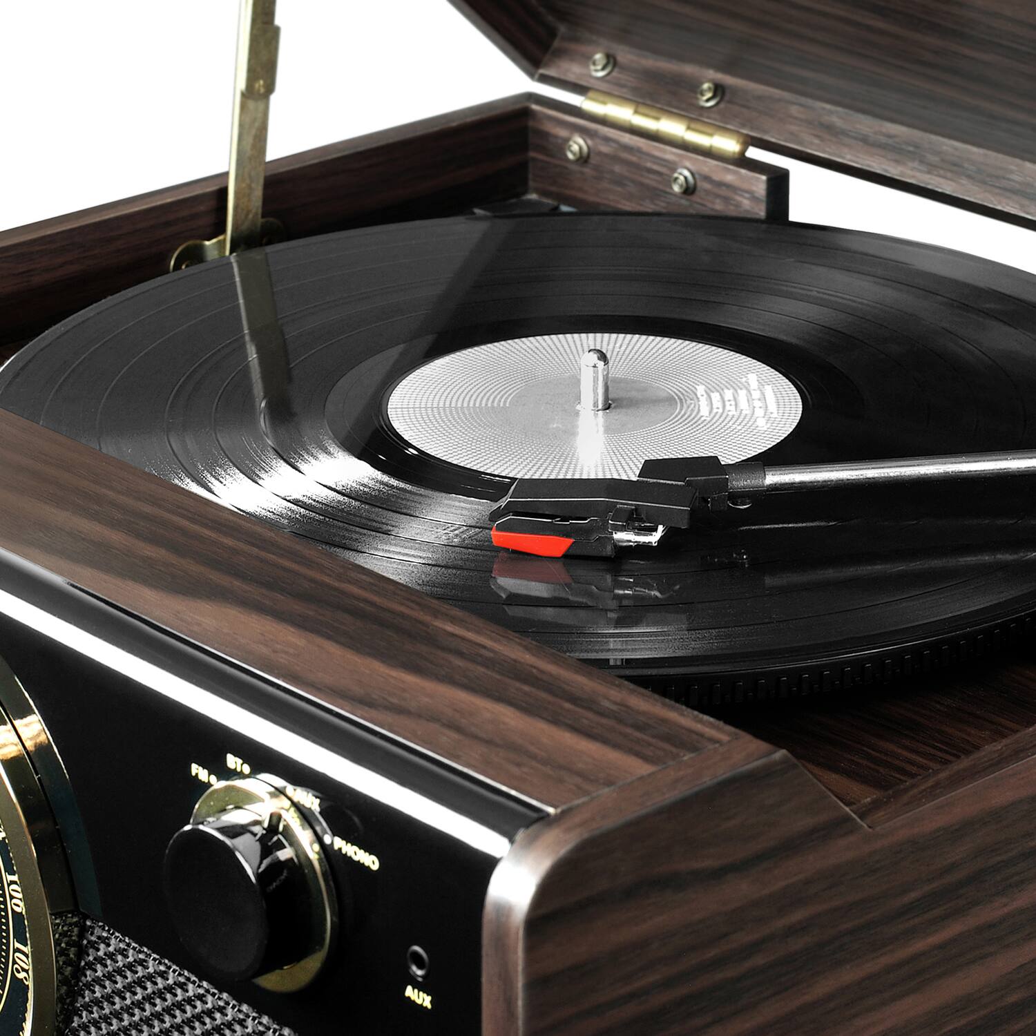 The image features a record player with a record on it. The record player is made of wood and has a clock on it. The record is placed on the turntable, ready to be played. The record player is an old-fashioned device that has been preserved and is still functional.
