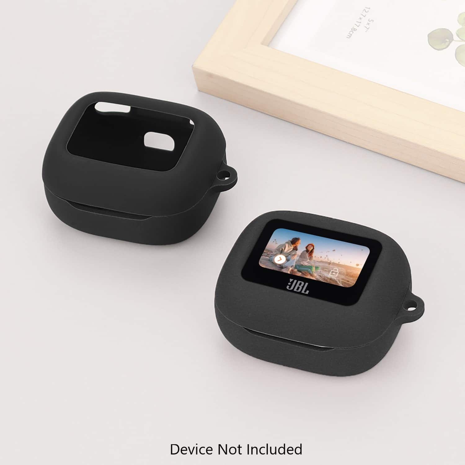 The image features a black device not included, placed on a white background. The device is accompanied by a small picture frame, which is also black. The frame is positioned on the left side of the device, and the device is placed on the right side of the frame. The overall size of the device is 12.7x17.8cm, or 5x7" in size.