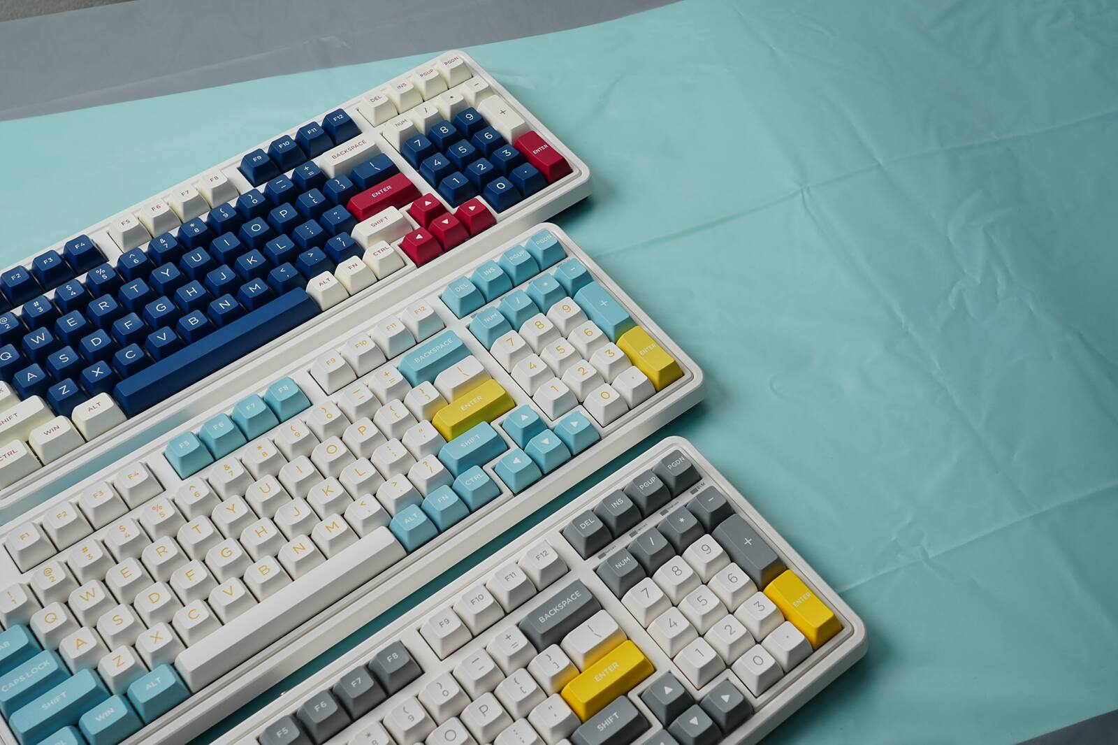 Sure, here is the corrected and grouped text from the image:

**Top Row:**
- F1 F2 F3 F4 F5 F6 F7 F8 F9 F10 F11 F12

**Second Row:**
- Q W E R T Y U I O P

**Third Row:**
- A S D F G H J K L ; '

**Fourth Row:**
- Z X C V B N M , . /

**Fifth Row:**
- Shift Z X C V B N M , . / Shift

**Sixth Row:**
- Caps Lock A S D F G H J K L ; '

**Seventh Row:**
- Alt F10 F9 F8 F7 F6 F5 F4 F3 F2 F1 Enter

**Eighth Row:**
- Ctrl Fn Alt Spacebar

**Numpad:**
- 7 8 9 + 4 5 6 - 1 2 3 Enter 0 . / Num Lock

**Additional Keys:**
- Backspace Enter Shift Ctrl Alt Win

**Color Variations:**
- Blue, Red, White, Yellow, Gray

**Other Keys:**
- Esc, Insert